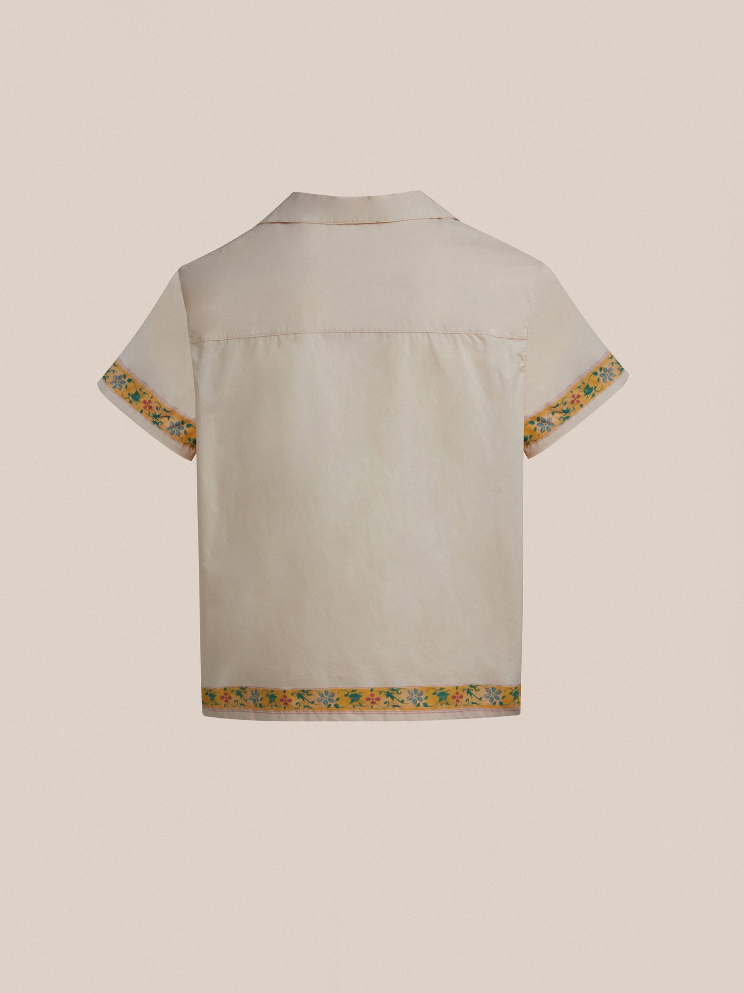The back of a white Found Moth Camp Shirt with yellow trim.