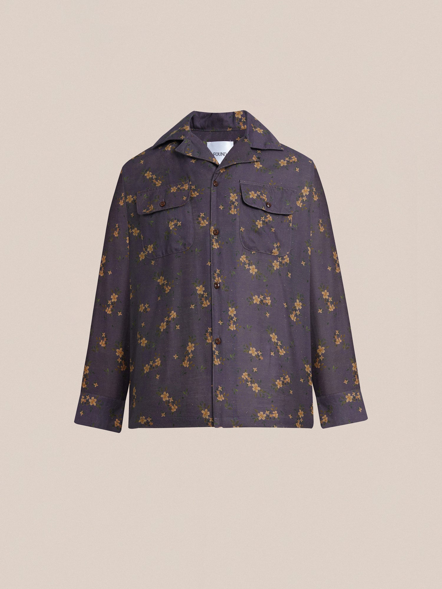 A Dusty LS Camp Shirt from Found with a flower print on it, offering a classic appeal.