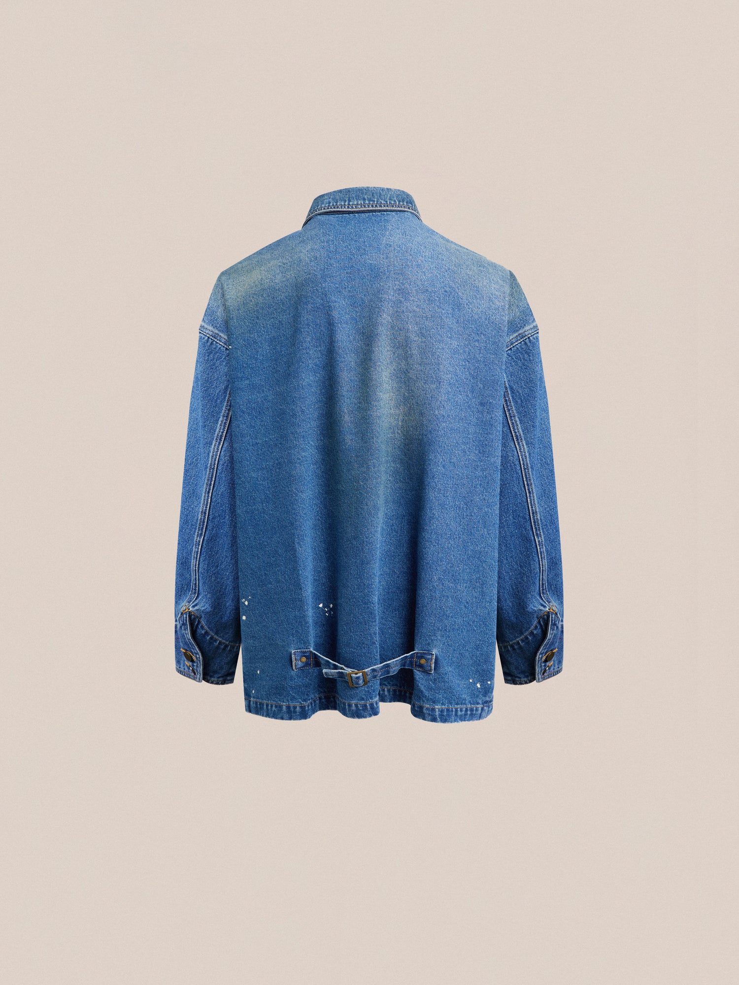The back view of a Kavir Denim Painter Jacket by Found with pockets.
