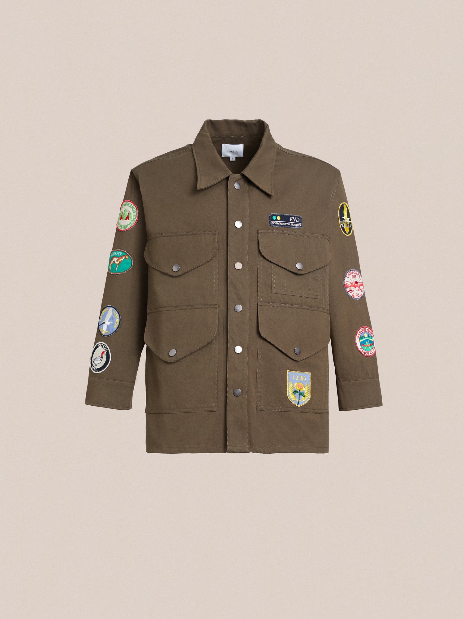 A Found Ports Park Multi Patch Work Jacket with embroidered patches on it.
