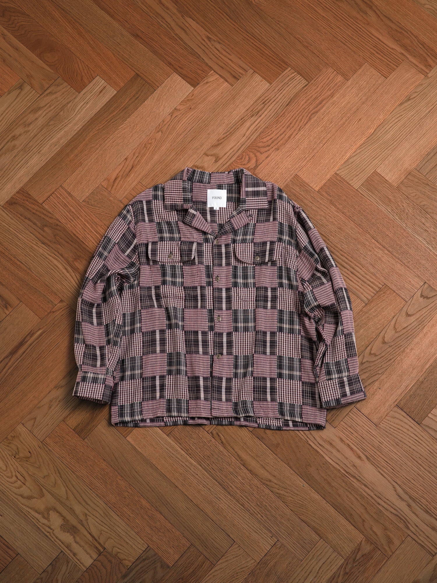 A timeless silhouette Multi-Flannel LS Camp Shirt by Found on a wooden floor.