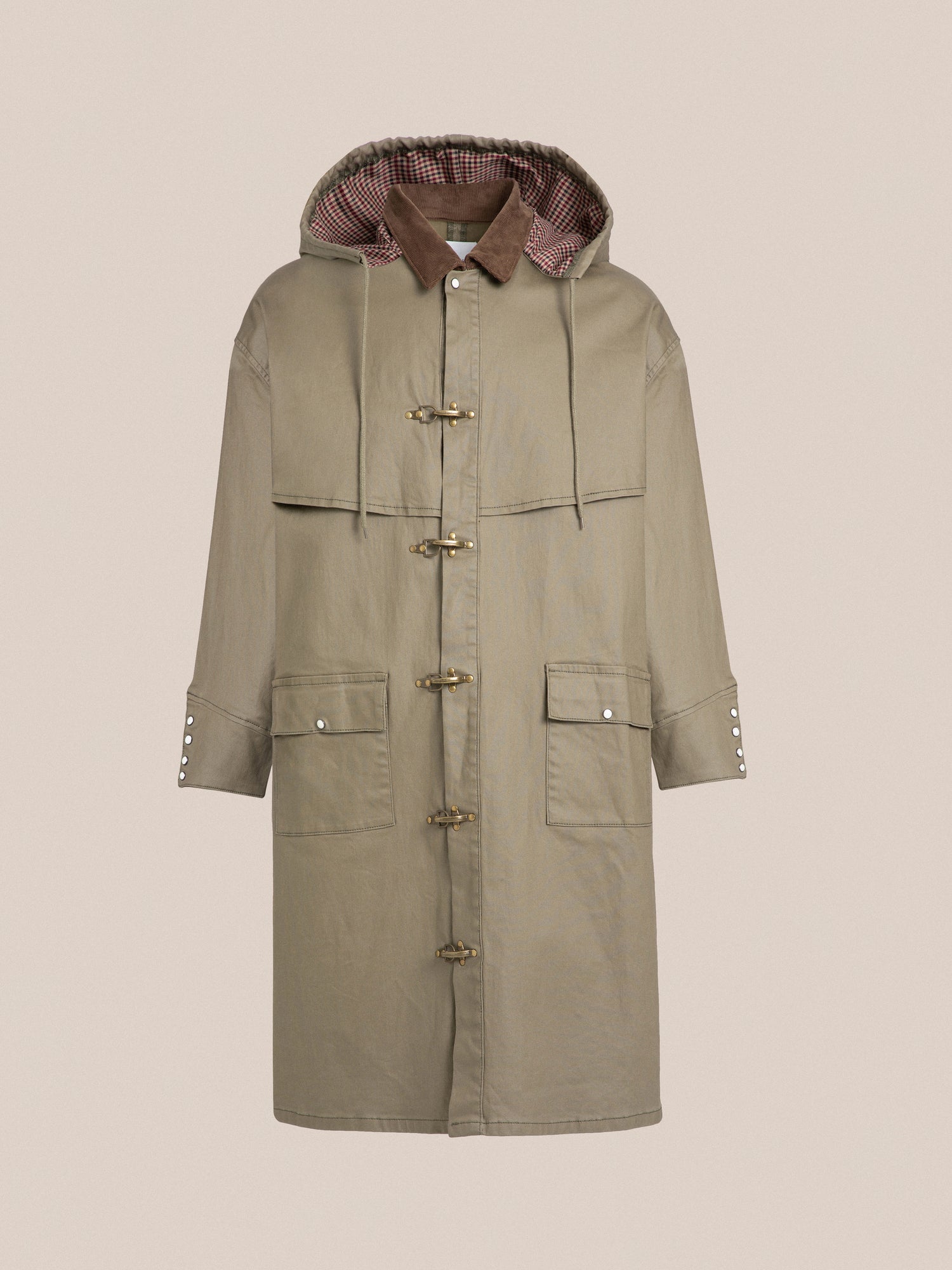 A Prairie Buckle Coat in beige with a hooded hood, featuring fireman clasps by Found.