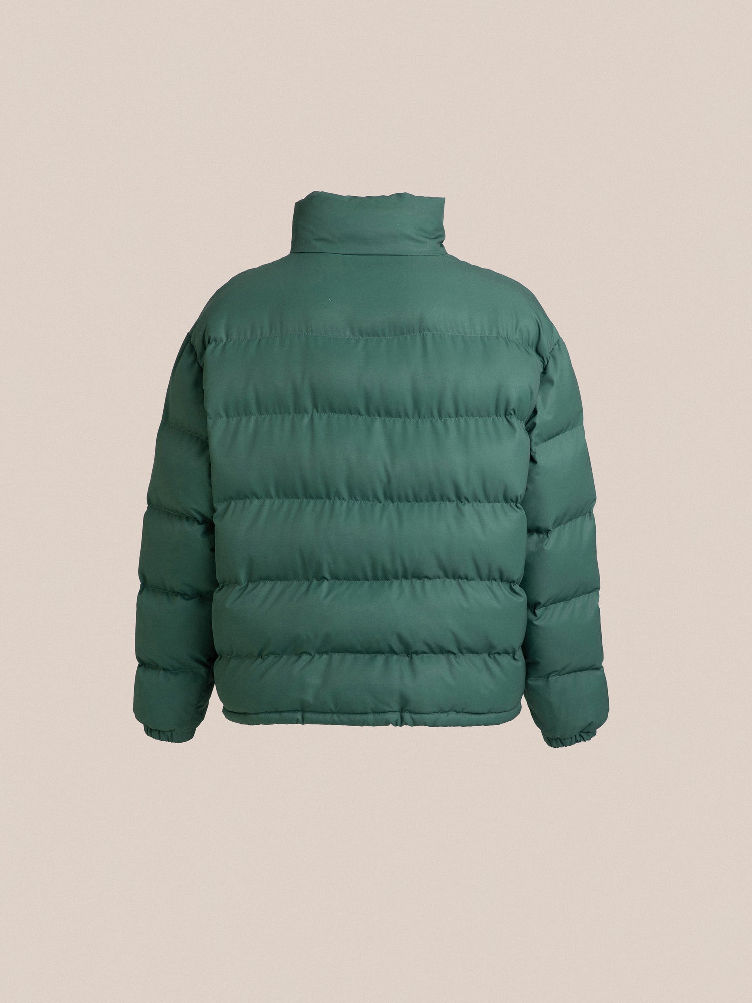 The back view of a Found Laurel Pine green hue puffer jacket.