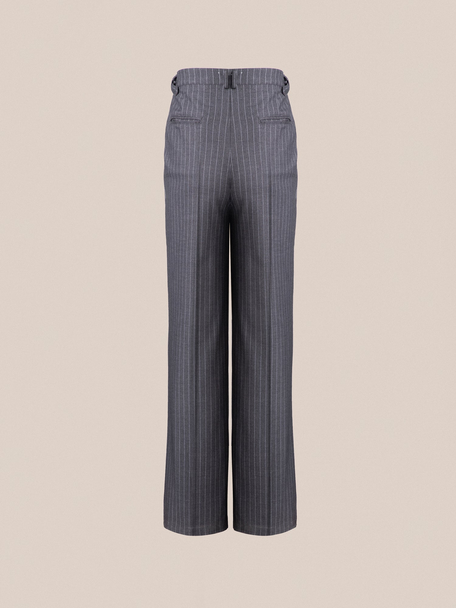 A pair of Found Pinstripe Pleated Trousers on a beige background.