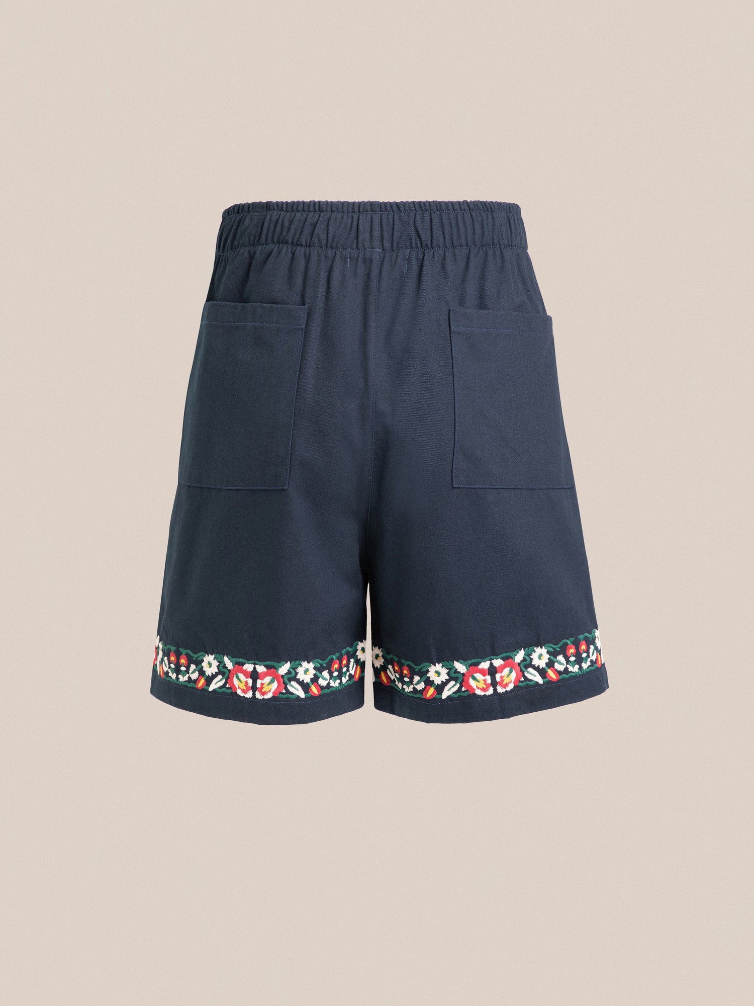 Navy blue Horse Equine Twill Shorts with floral embroidery along the hem, featuring elastic waistband and large front pockets, displayed against a neutral background by Found.