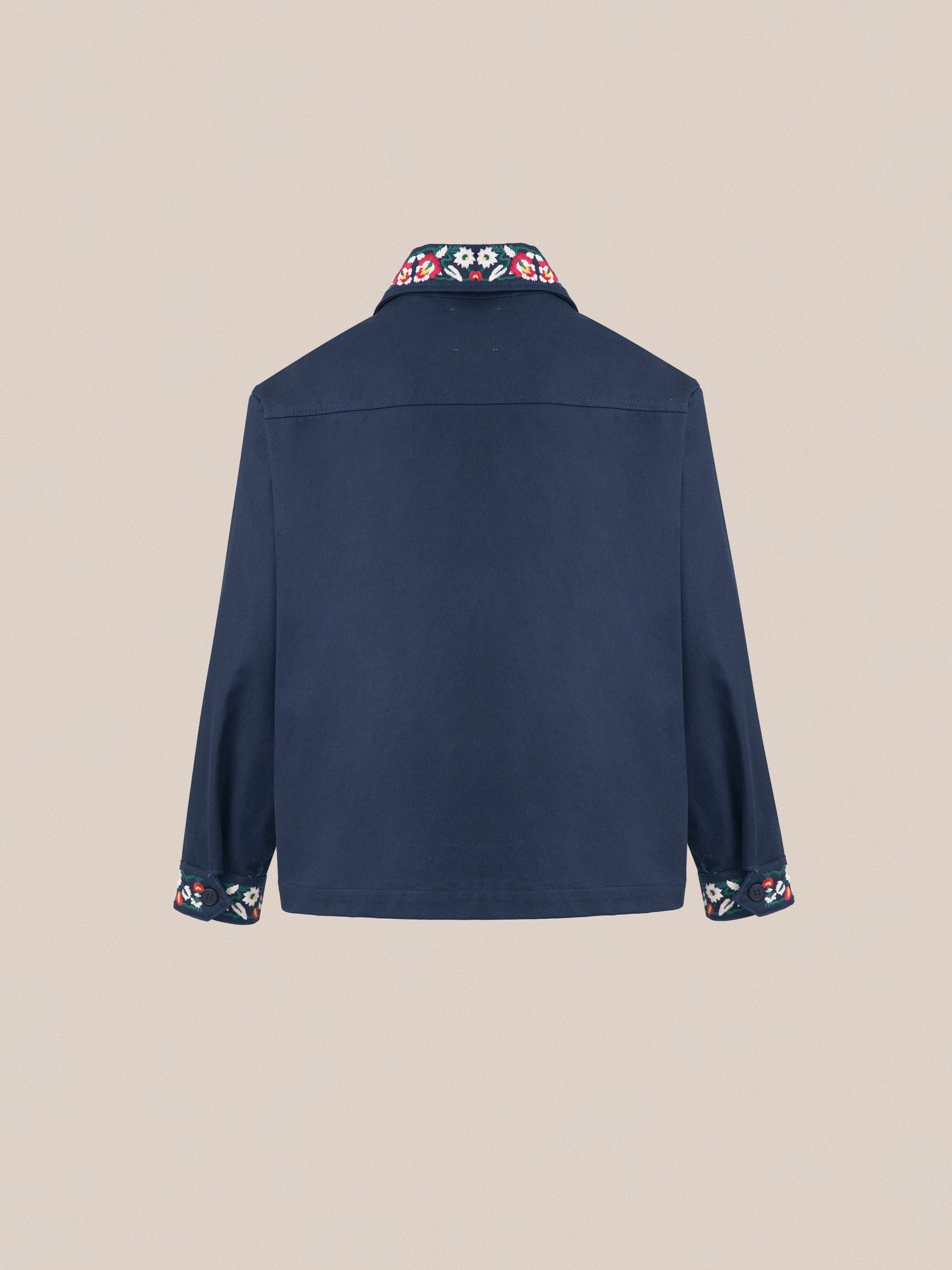 The back view of a Found Horse Equine Work Jacket with floral detailing and color blocking.