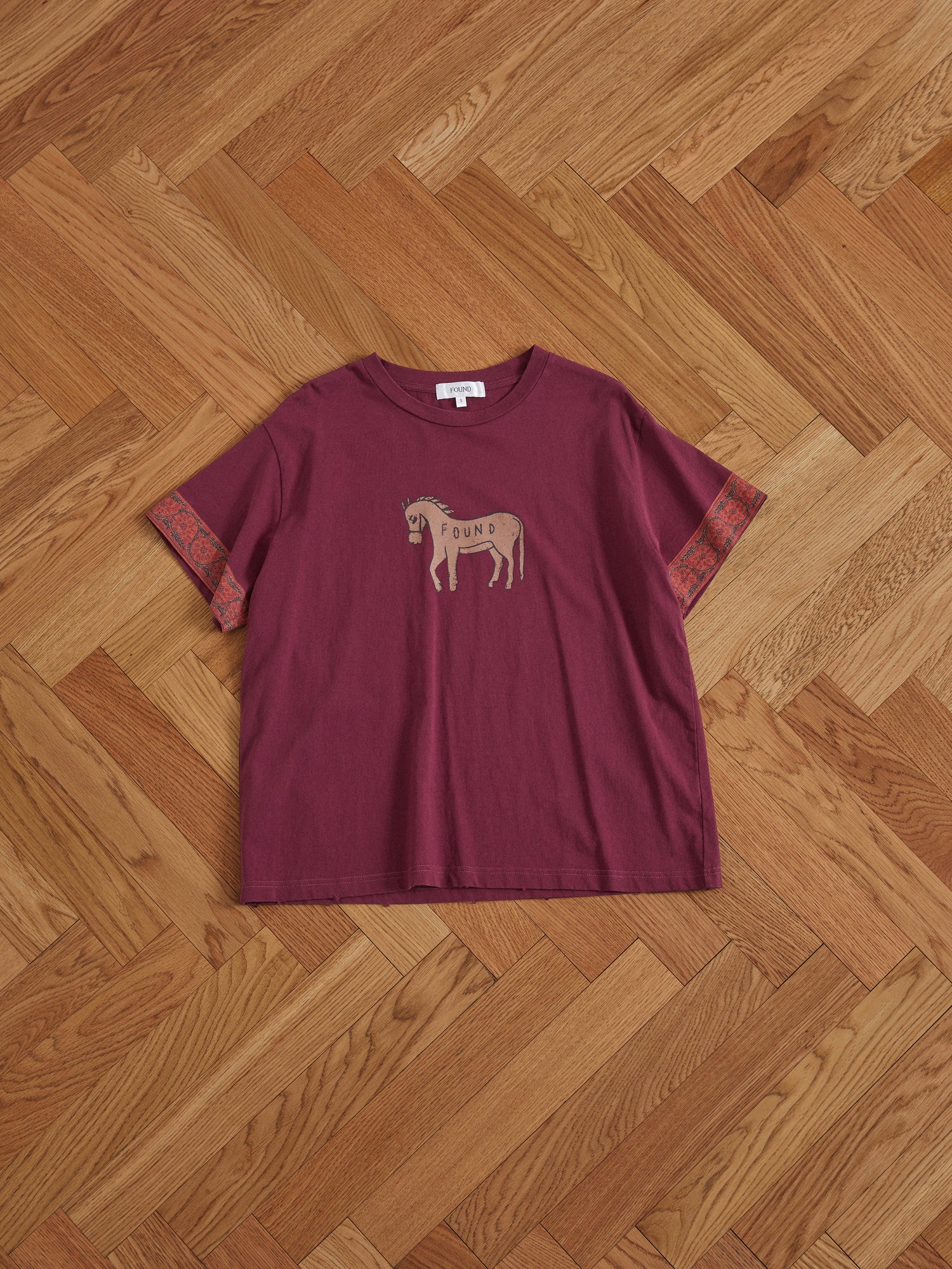 A maroon Found Horse Embellishment tee with a horse on it.