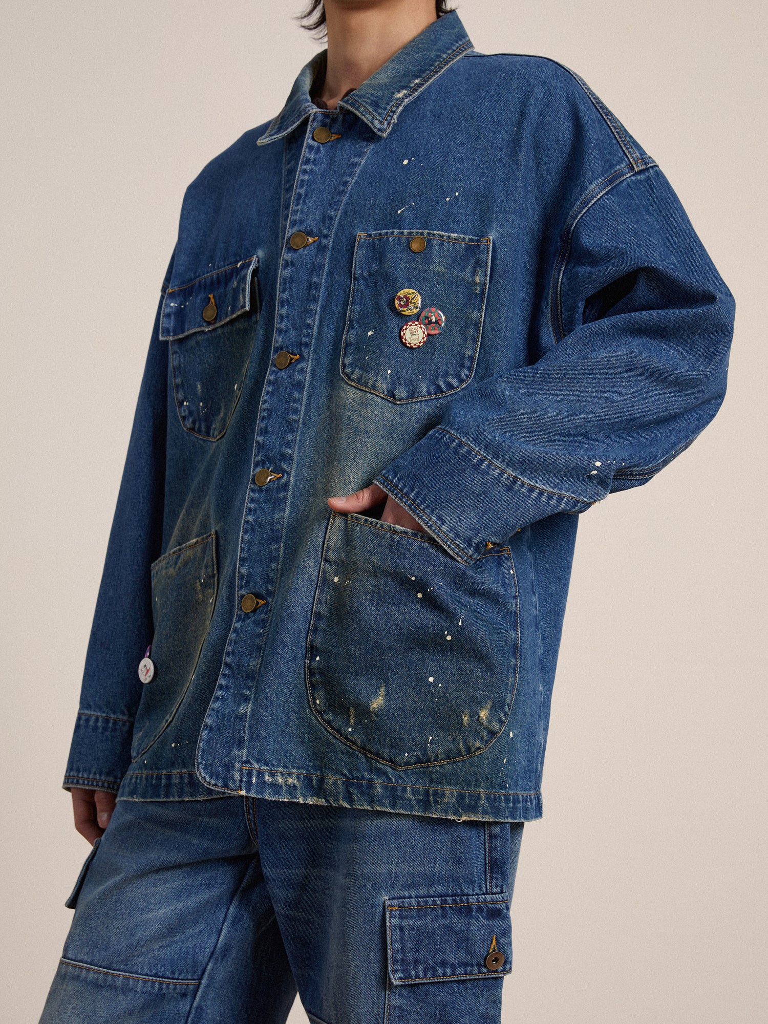 A model wearing a Kavir Denim Painter Jacket designed by Found with buttons.