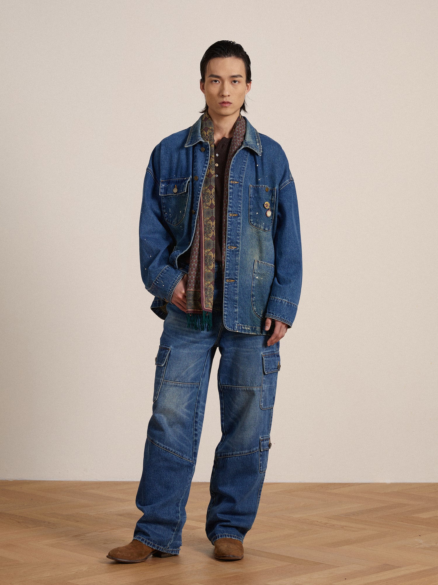 A model wearing a Kavir Denim Painter Jacket and jeans, styled by an artist from Found.