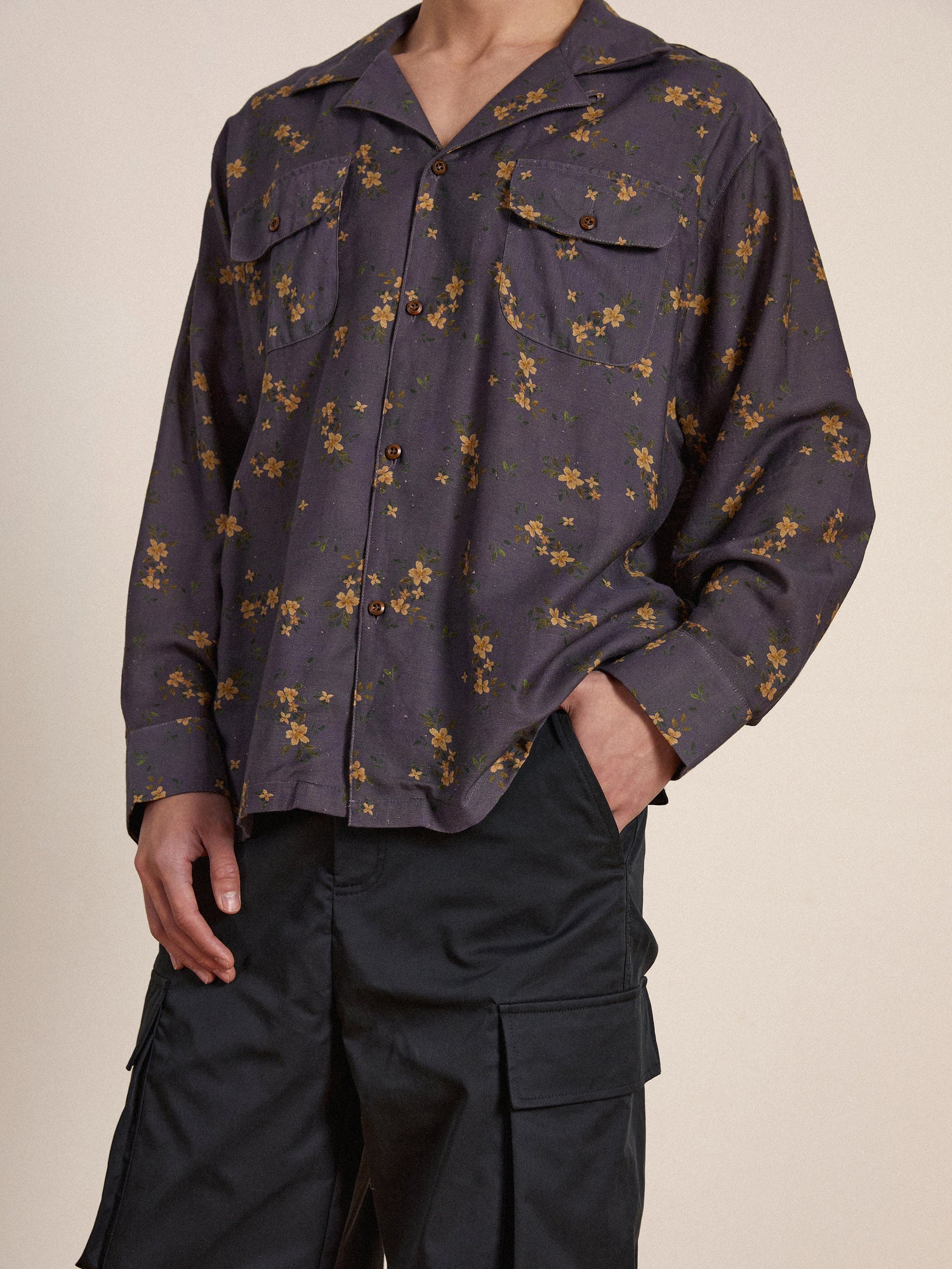 The model is wearing a Found Dusty LS Camp Shirt with flowers on it.
