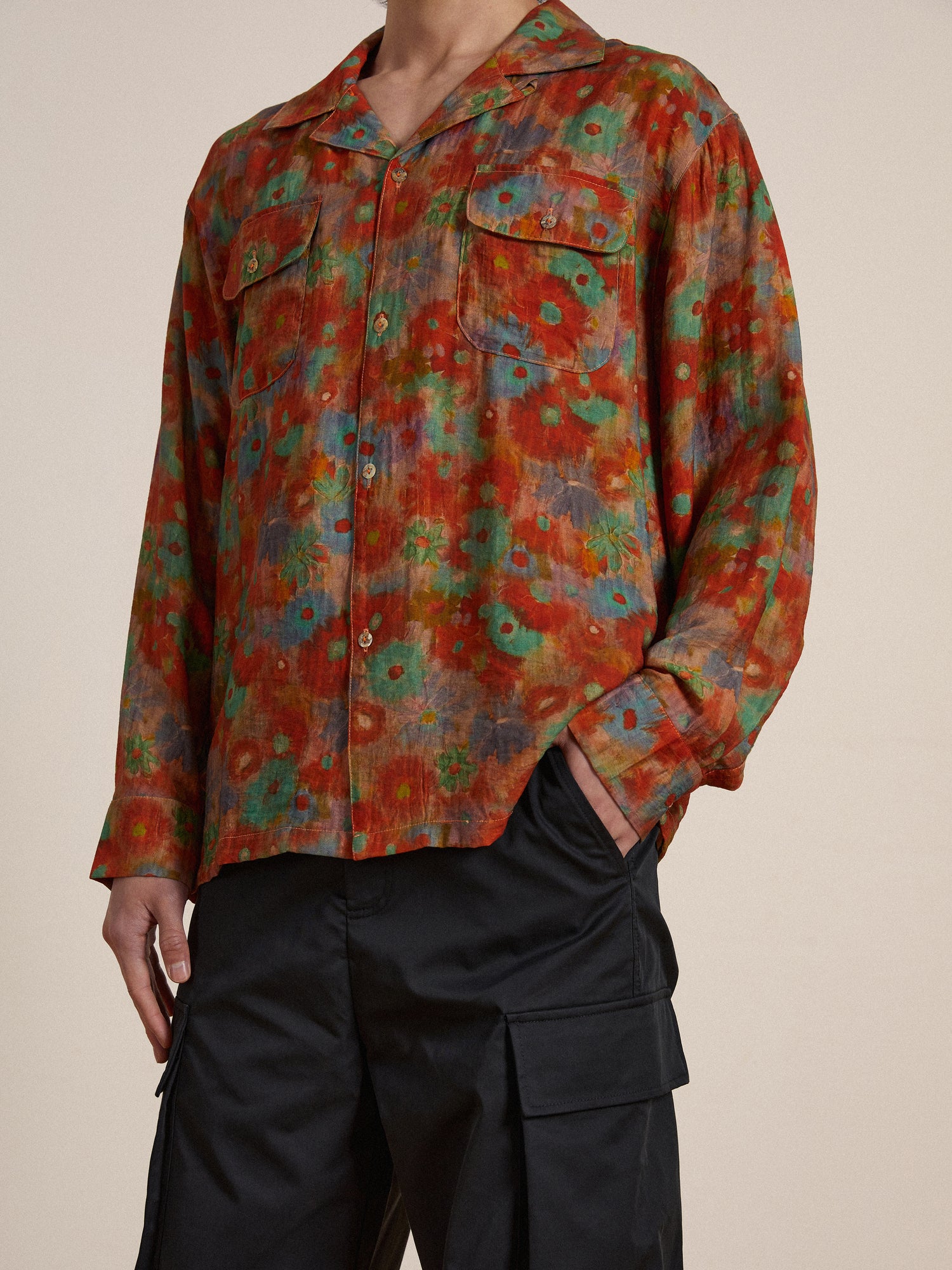 A man wearing a Found Waterblend LS Camp Shirt with a colorful print.