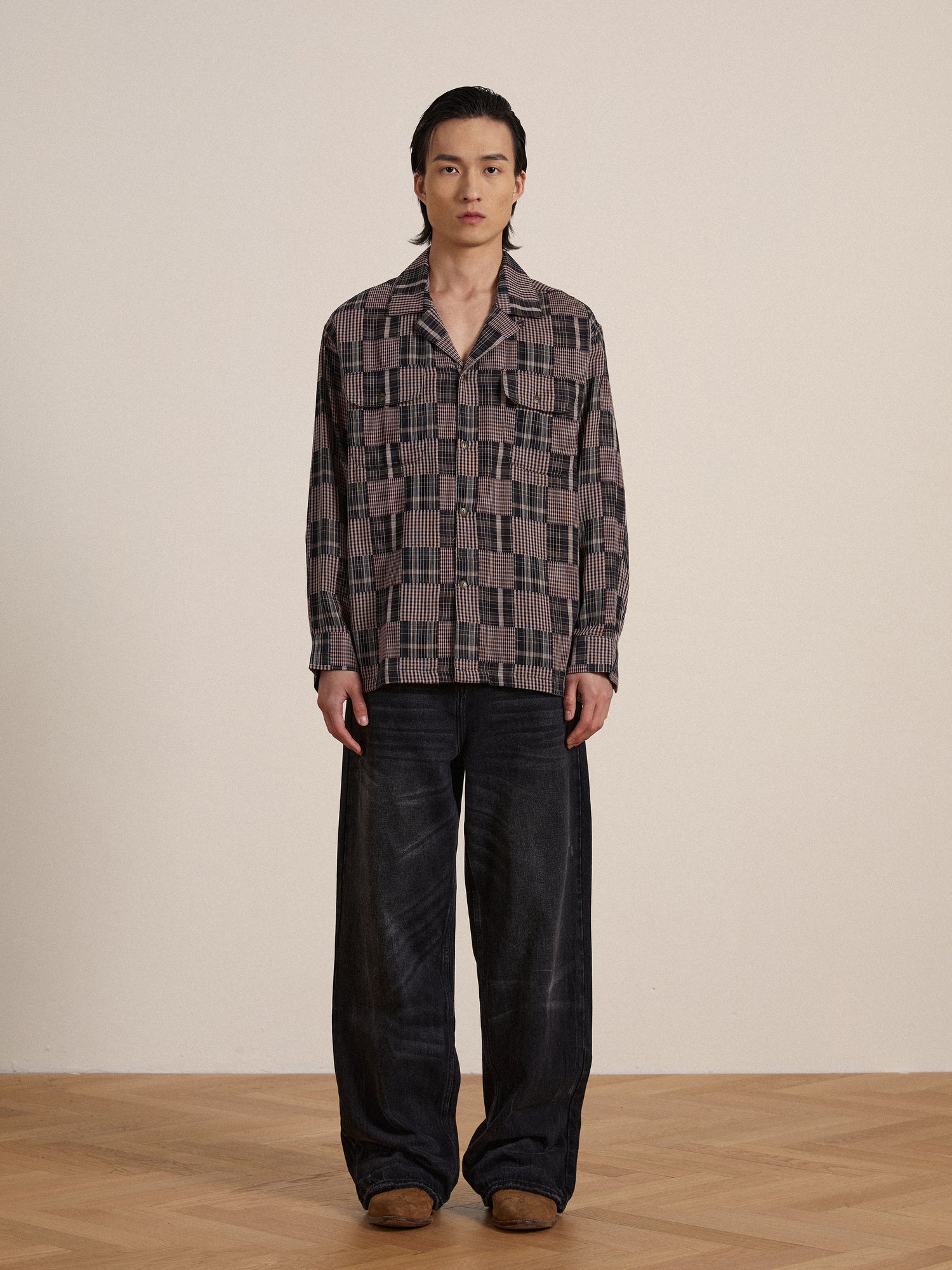 A man wearing a Found timeless silhouette multi-flannel LS camp shirt and black pants.