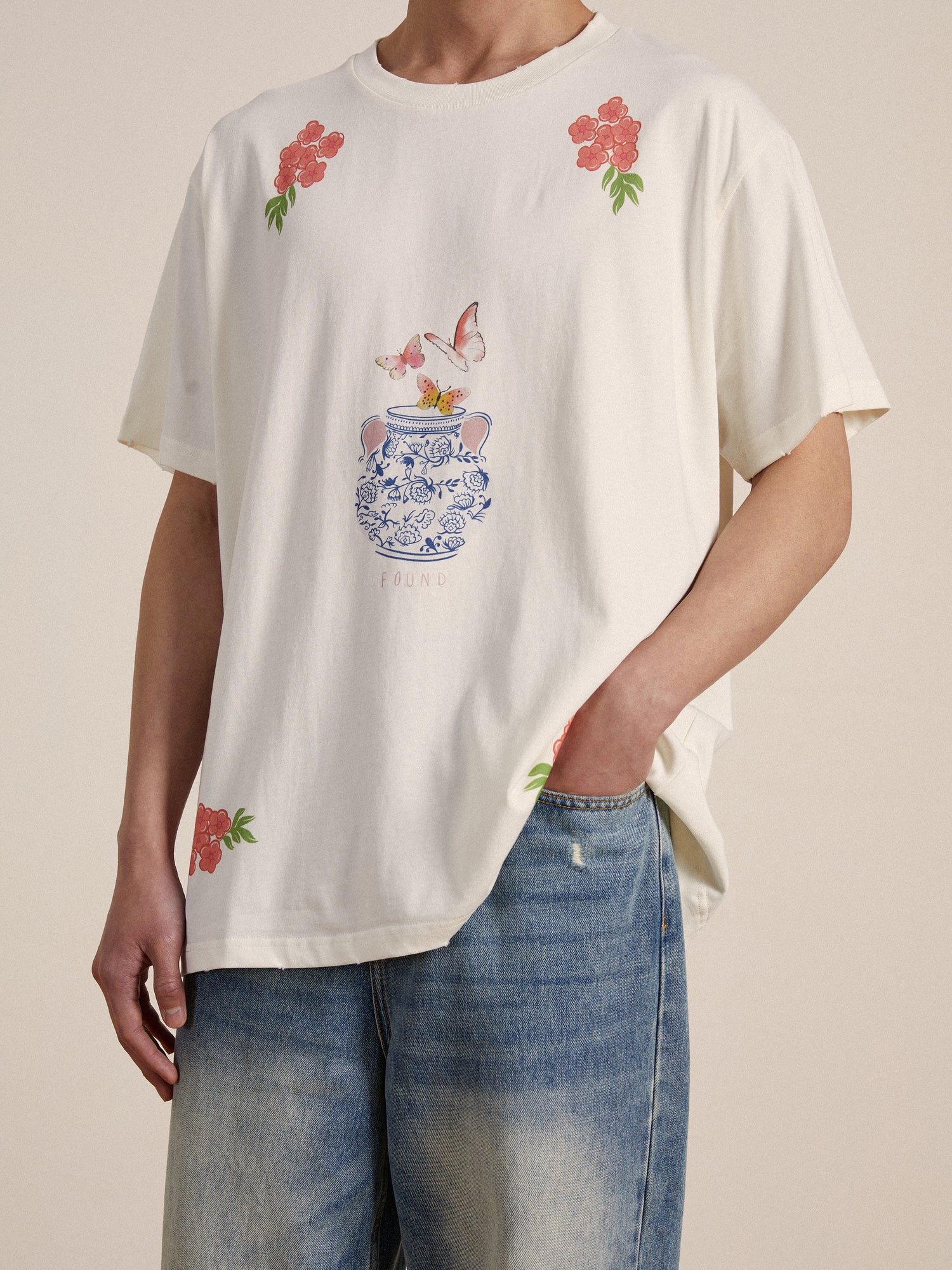 A man wearing a Found Flower Pot Tee and jeans.