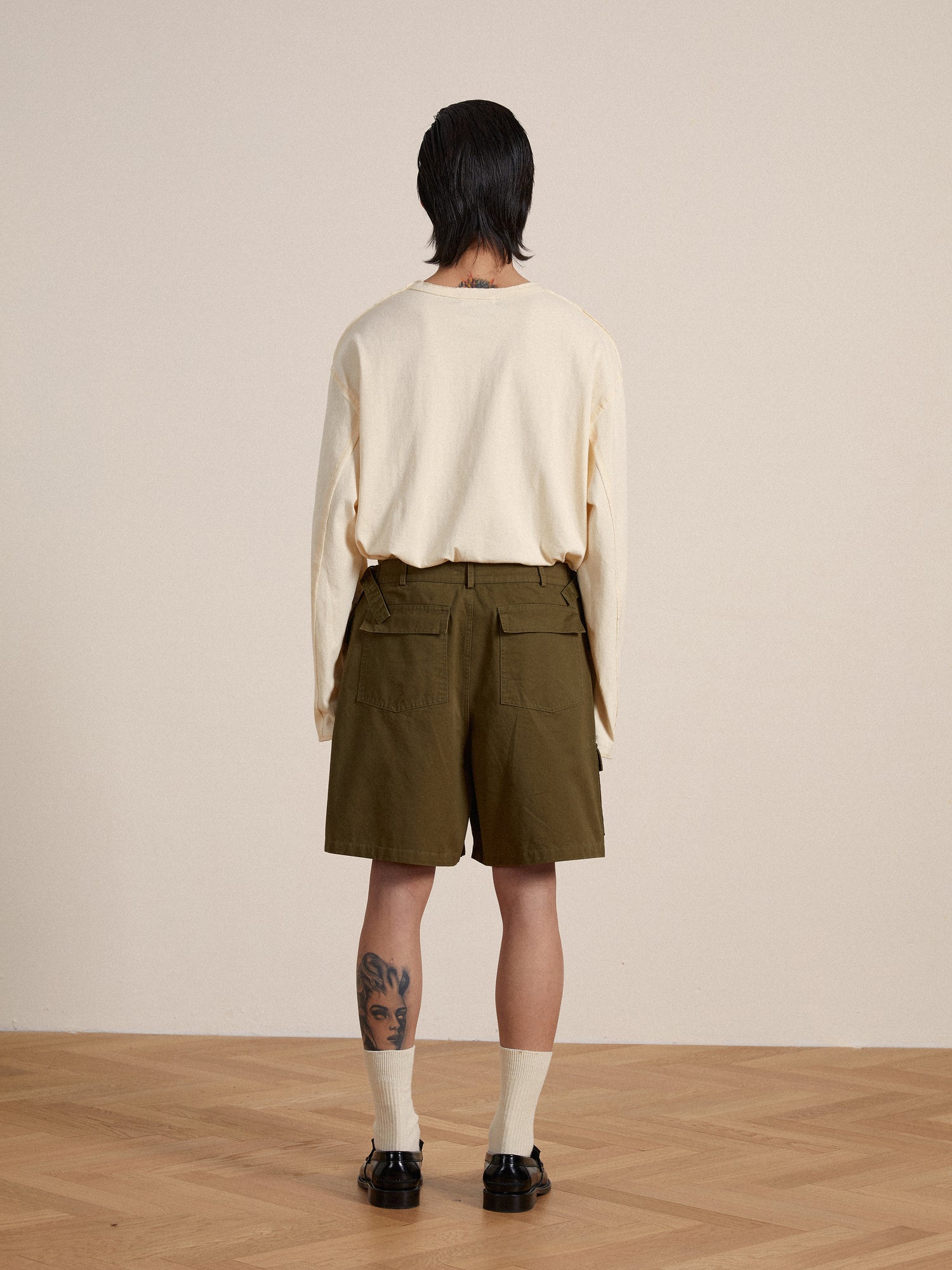 The back view of a man in olive Found Twill Cargo Shorts.