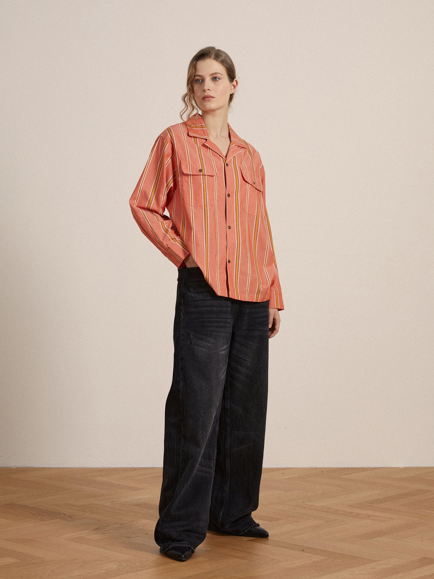 A model wearing a Found Stripe Citrus LS Camp Shirt and wide leg pants, both exuding timeless silhouette and classic appeal.
