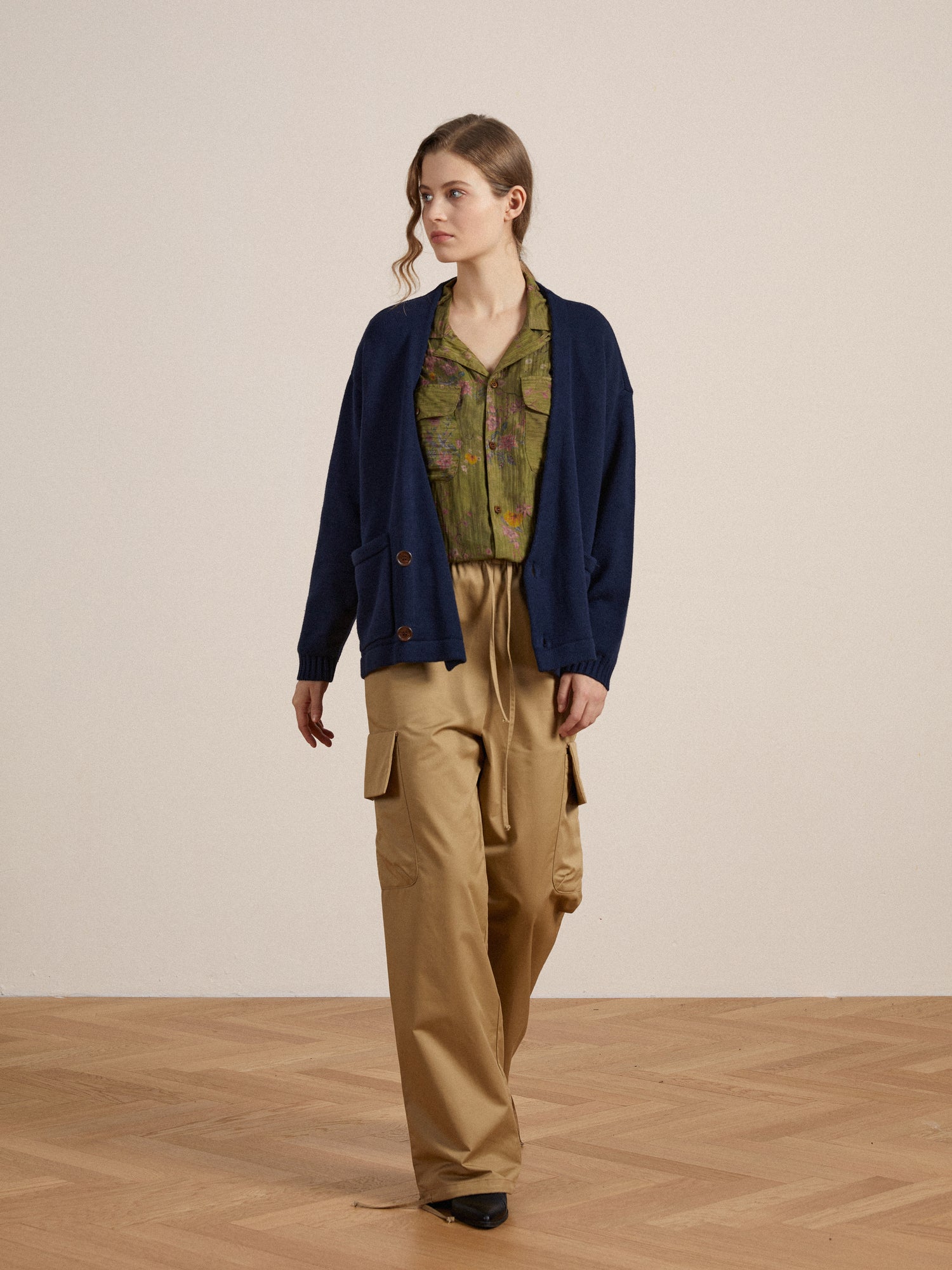 A woman in Found Floral Moss LS Camp Shirt and a navy cardigan.