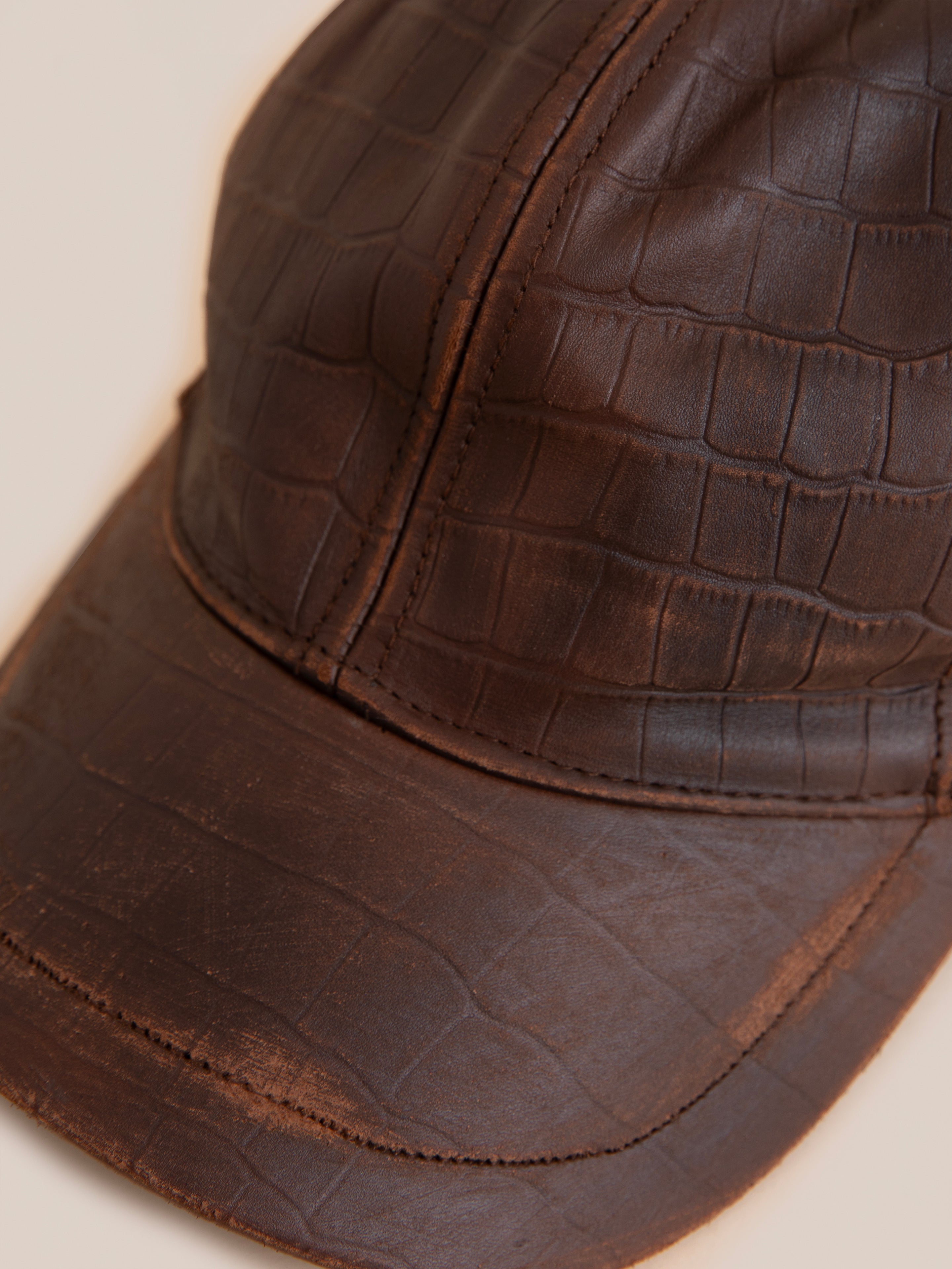 Close-up of the Found Croc Embossed Distressed Leather Cap, highlighting its unique textured pattern and stylish distressed design.