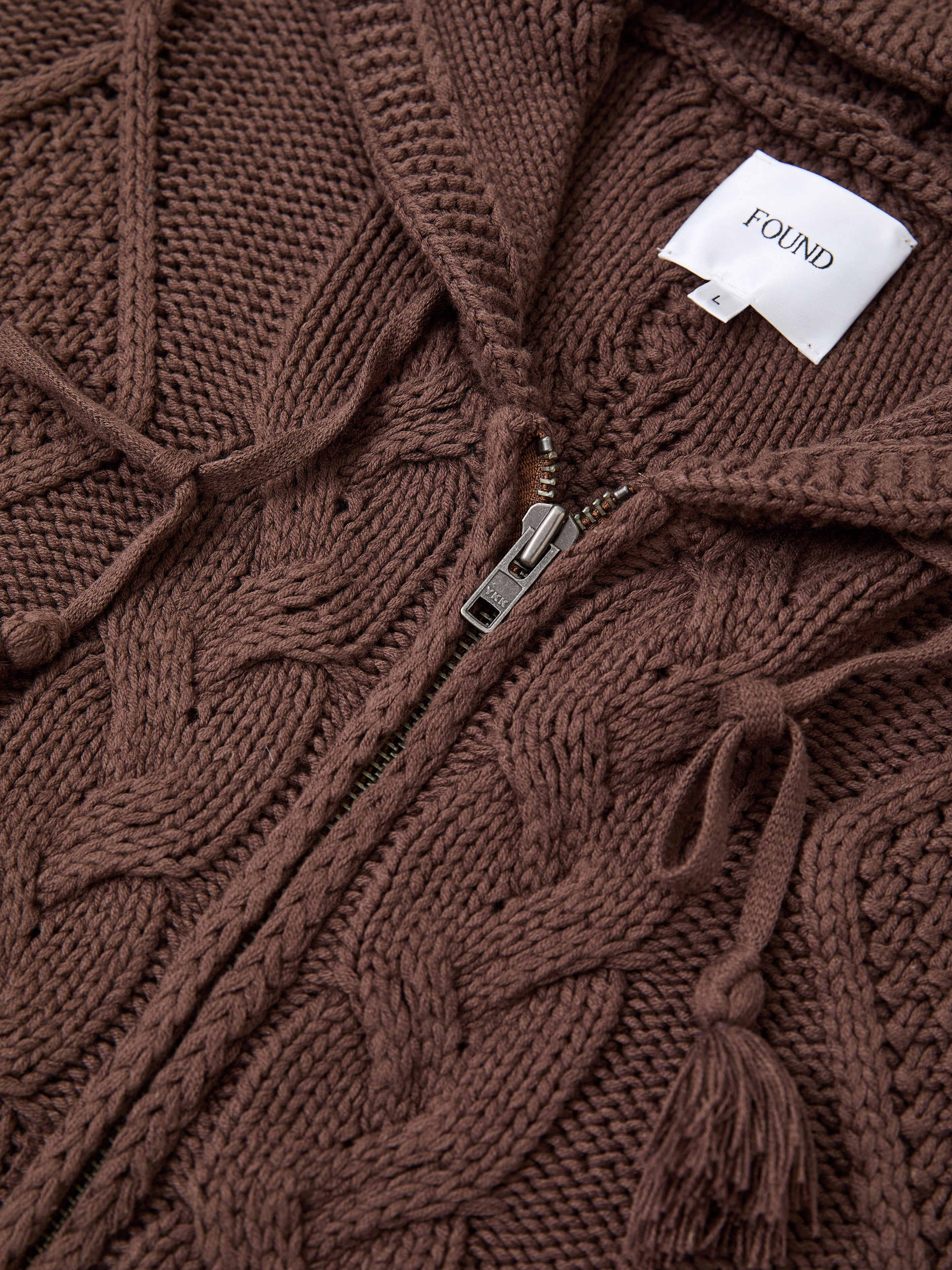 FOUND Zip Up Cable Knit Hoodie—relaxed fit with drawstrings, zipper, and white FOUND label; a vintage-inspired unisex knitwear staple.