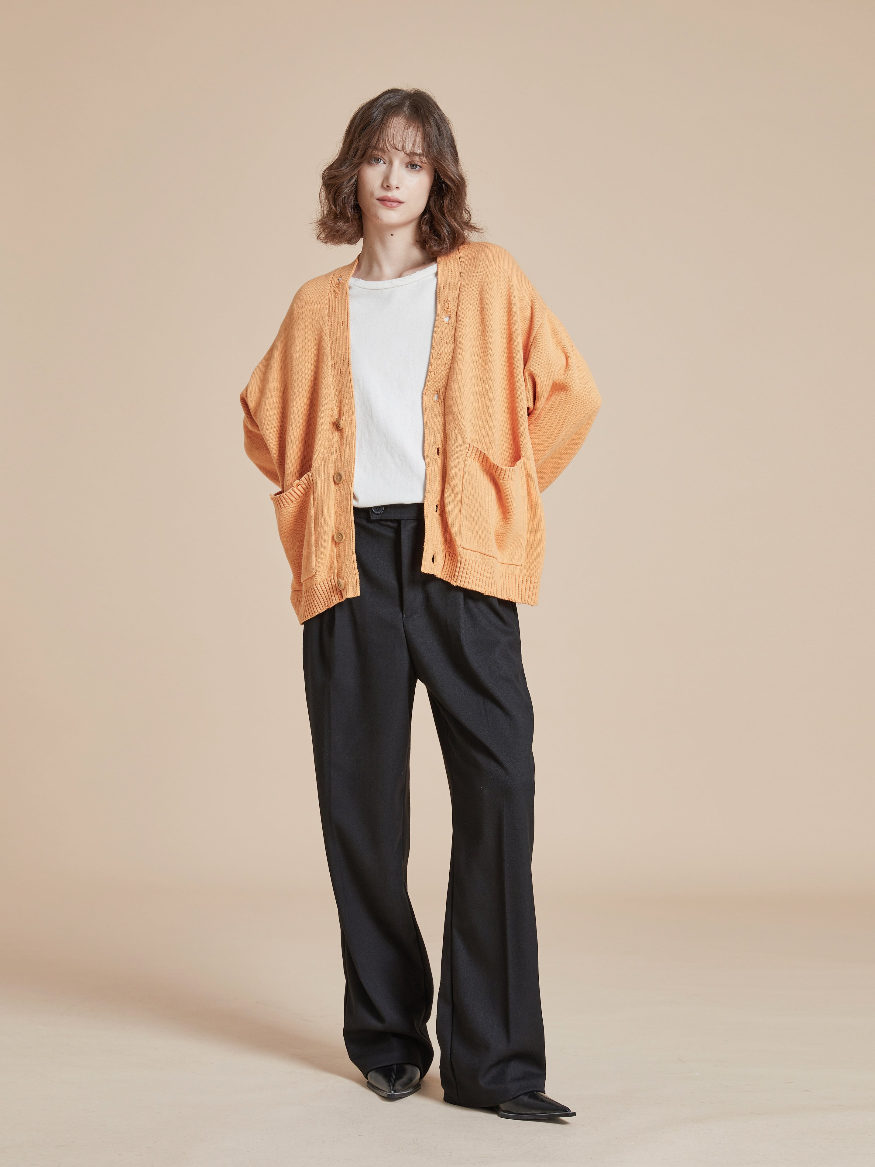 The model is wearing a Found Cadmium Distressed Cardigan.