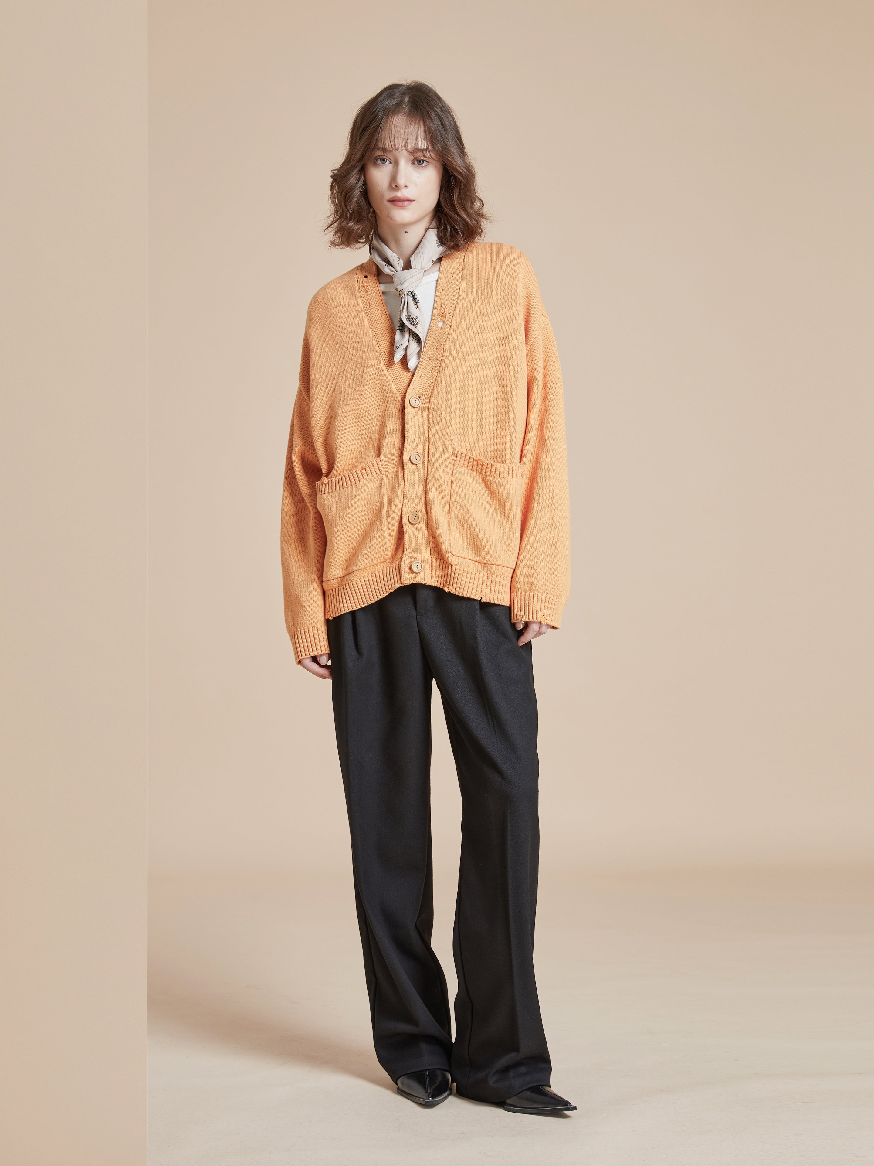A model wearing a Found Cadmium Distressed Cardigan.
