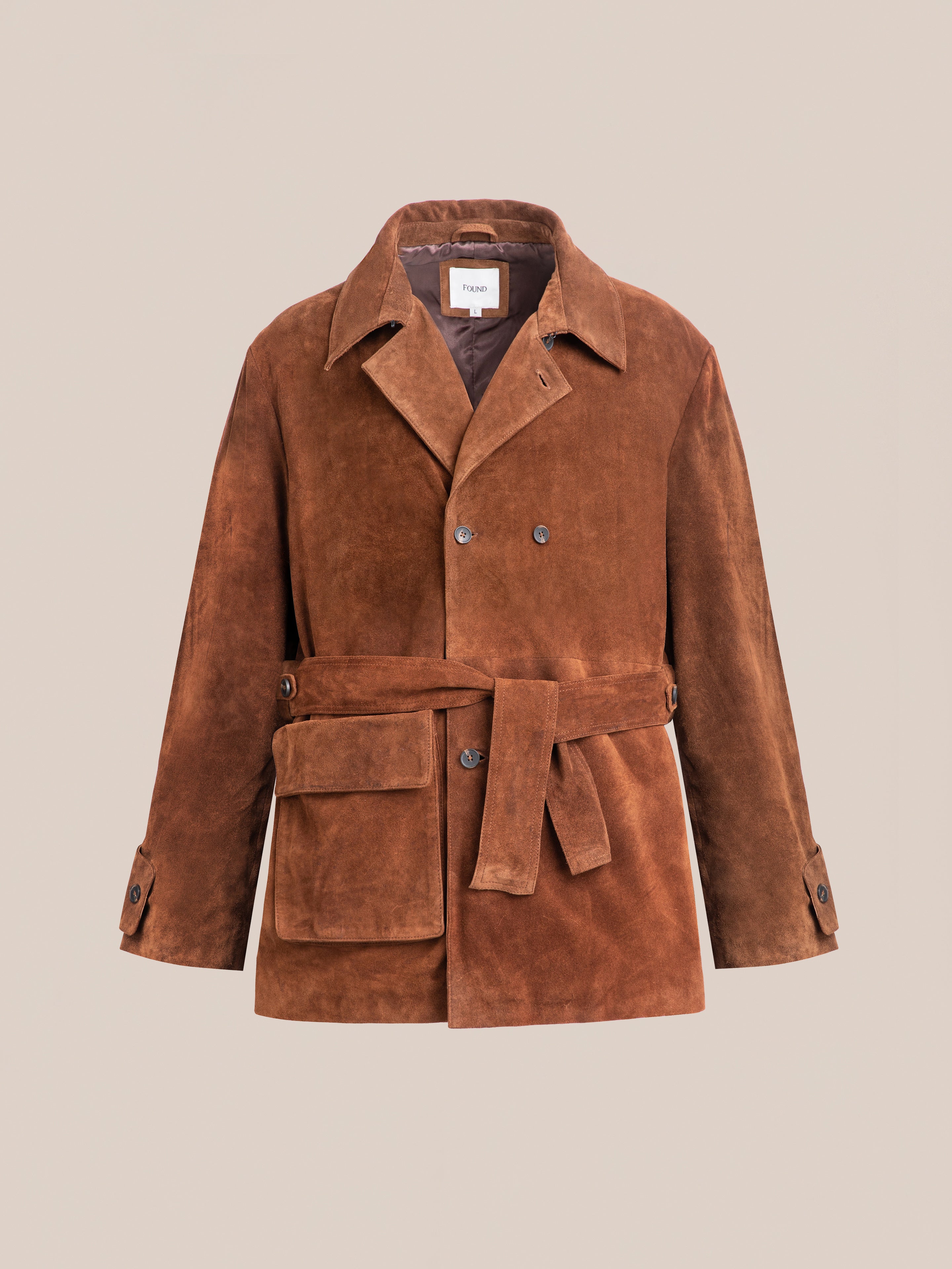 FOUND's ethically produced Double Breasted Suede Leather Jacket, in brown, features a belt, large pockets, and buttoned cuffs against a plain backdrop.