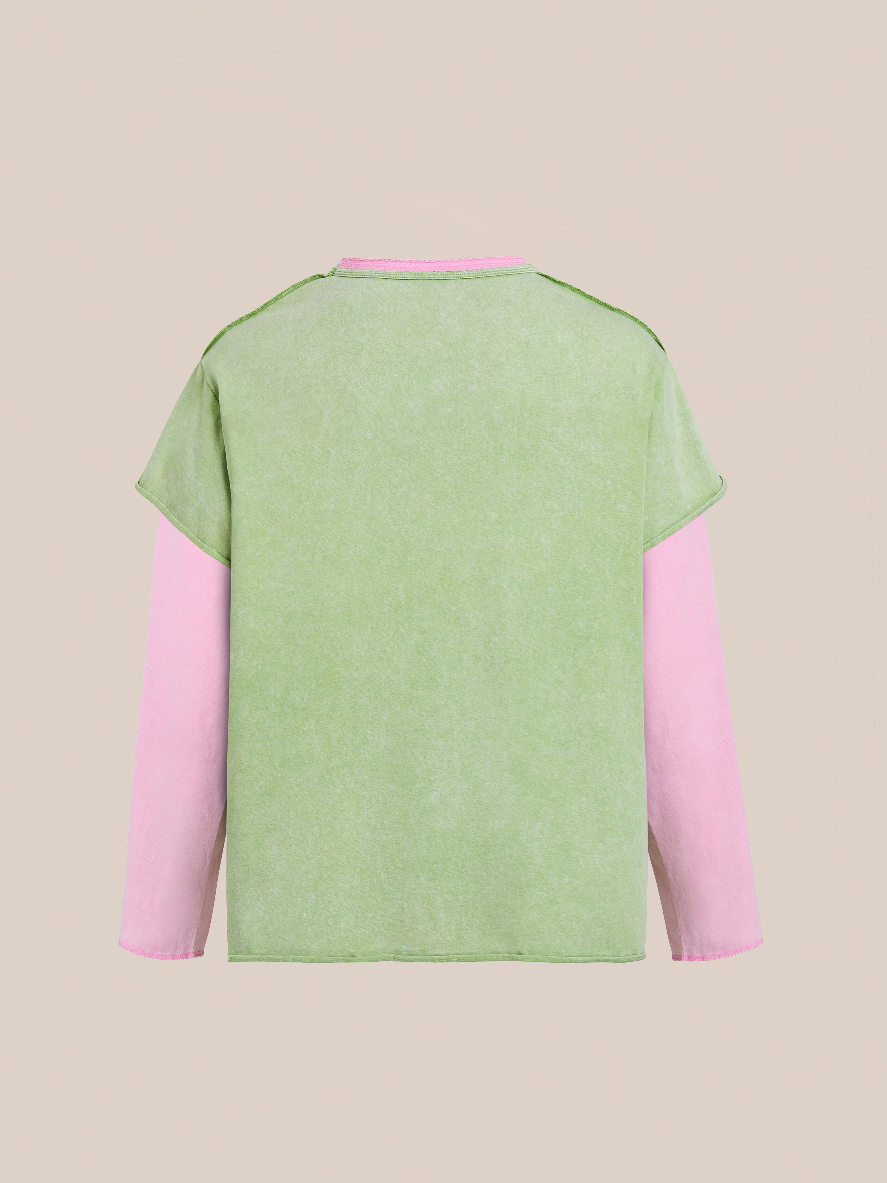 The FOUND Double Layer LS Tee is a unisex long sleeve shirt featuring a solid green back and pink sleeves, shown on a plain beige background.