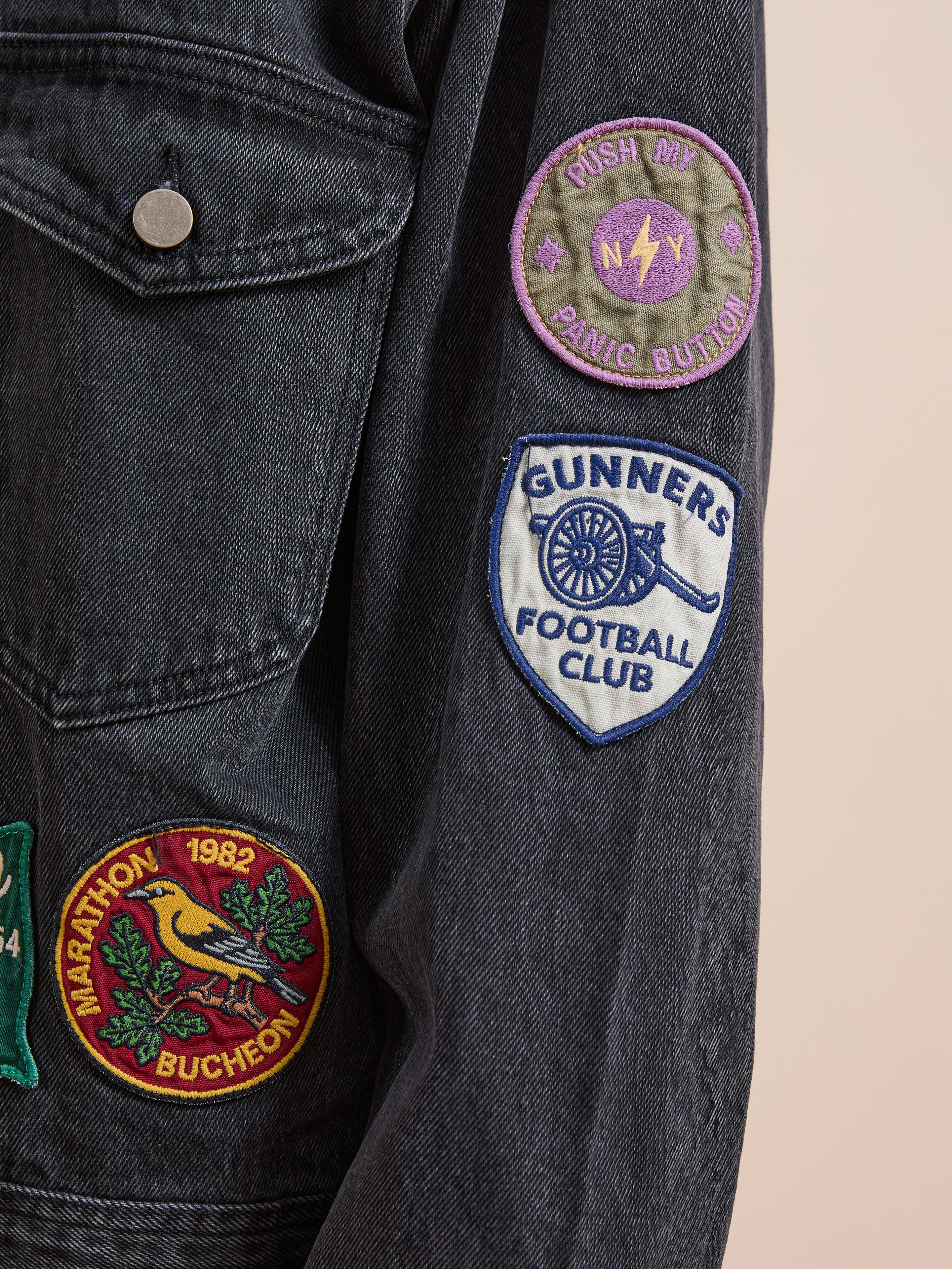 Close-up of FOUND’s Denim Patchwork Jacket showing a corduroy collar and sleeve with three Americana patches: "Push My Panic Button," "Gunners Football Club," and "Marathon Bucheon 1982.