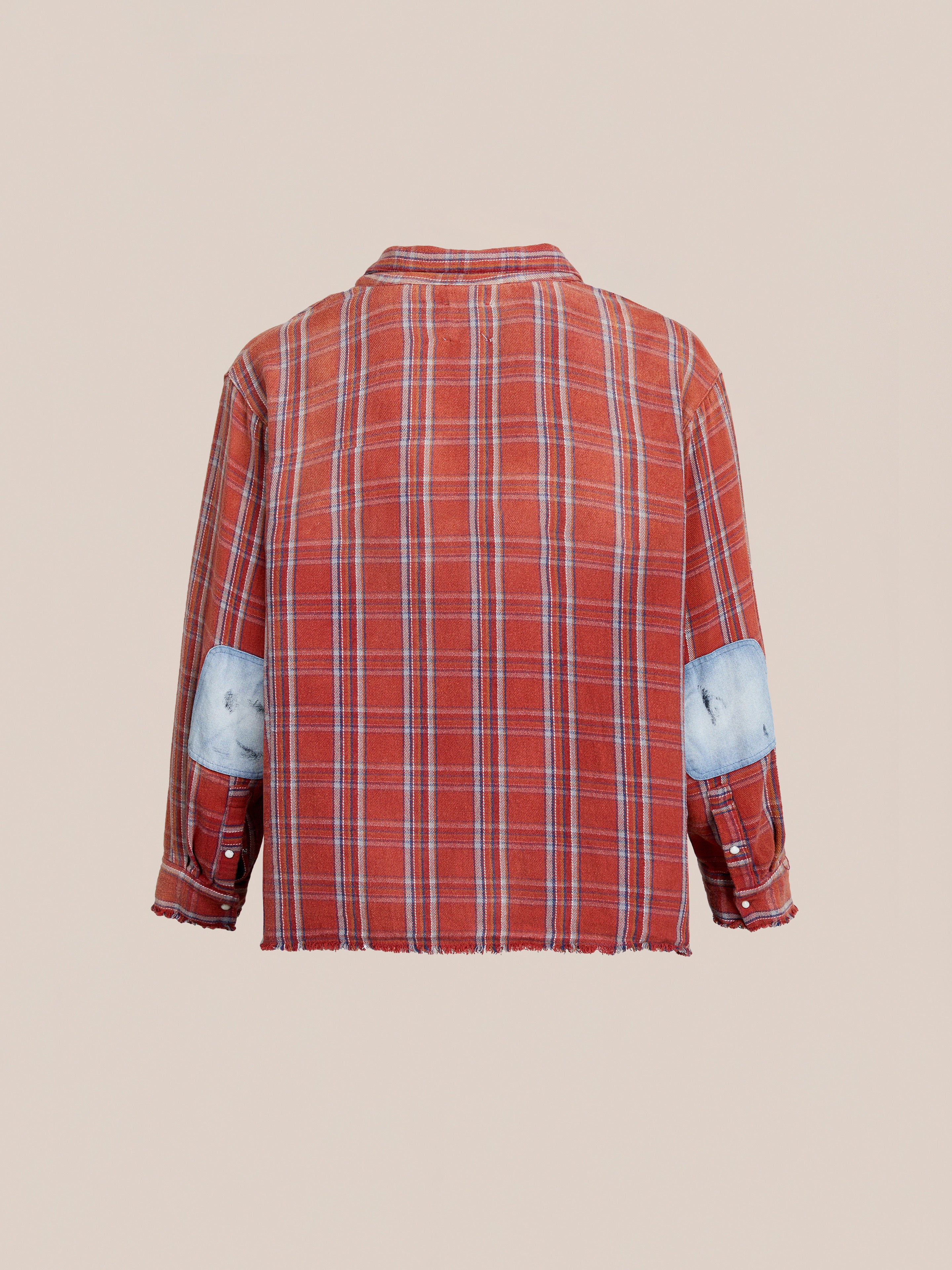 Back view of FOUND Plaid Denim Shirt, a unisex relaxed fit red plaid long-sleeve with white and blue elbow patches, shown on a plain beige background.