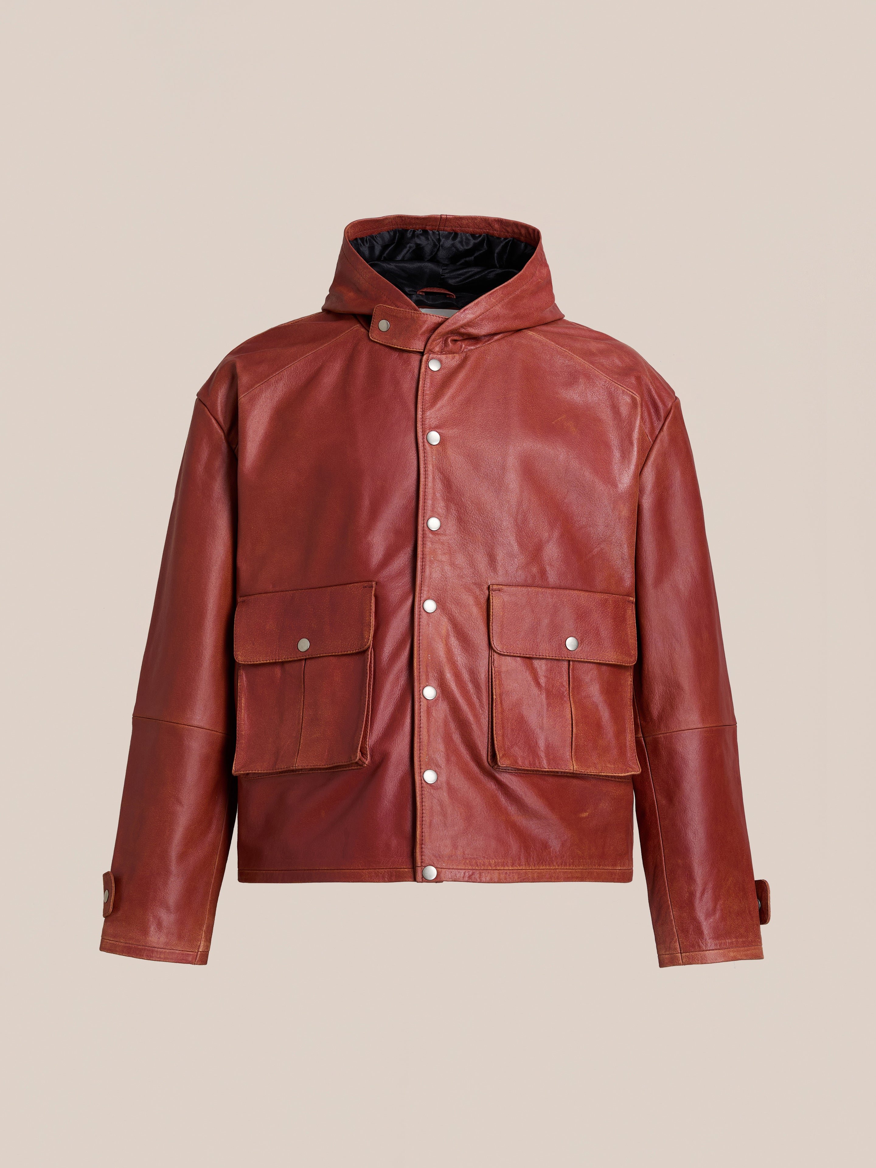 FOUND Distressed Leather Pocket Hoodie featuring a front snap-button closure, two large flap pockets, high collar, and adjustable cuffs, shown against a plain beige background.