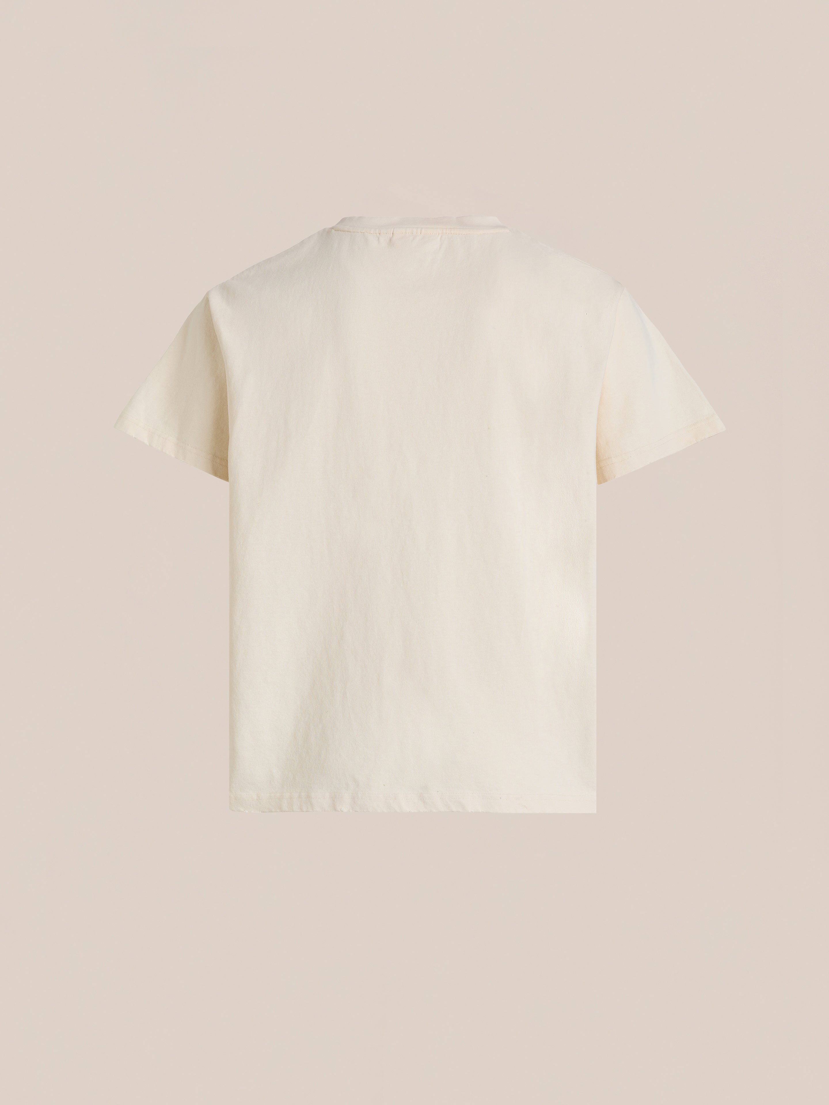 The FOUND Found Logo Flower Tee in beige is shown from the back against a plain background, featuring embroidered flowers that lend a subtle vintage feel.