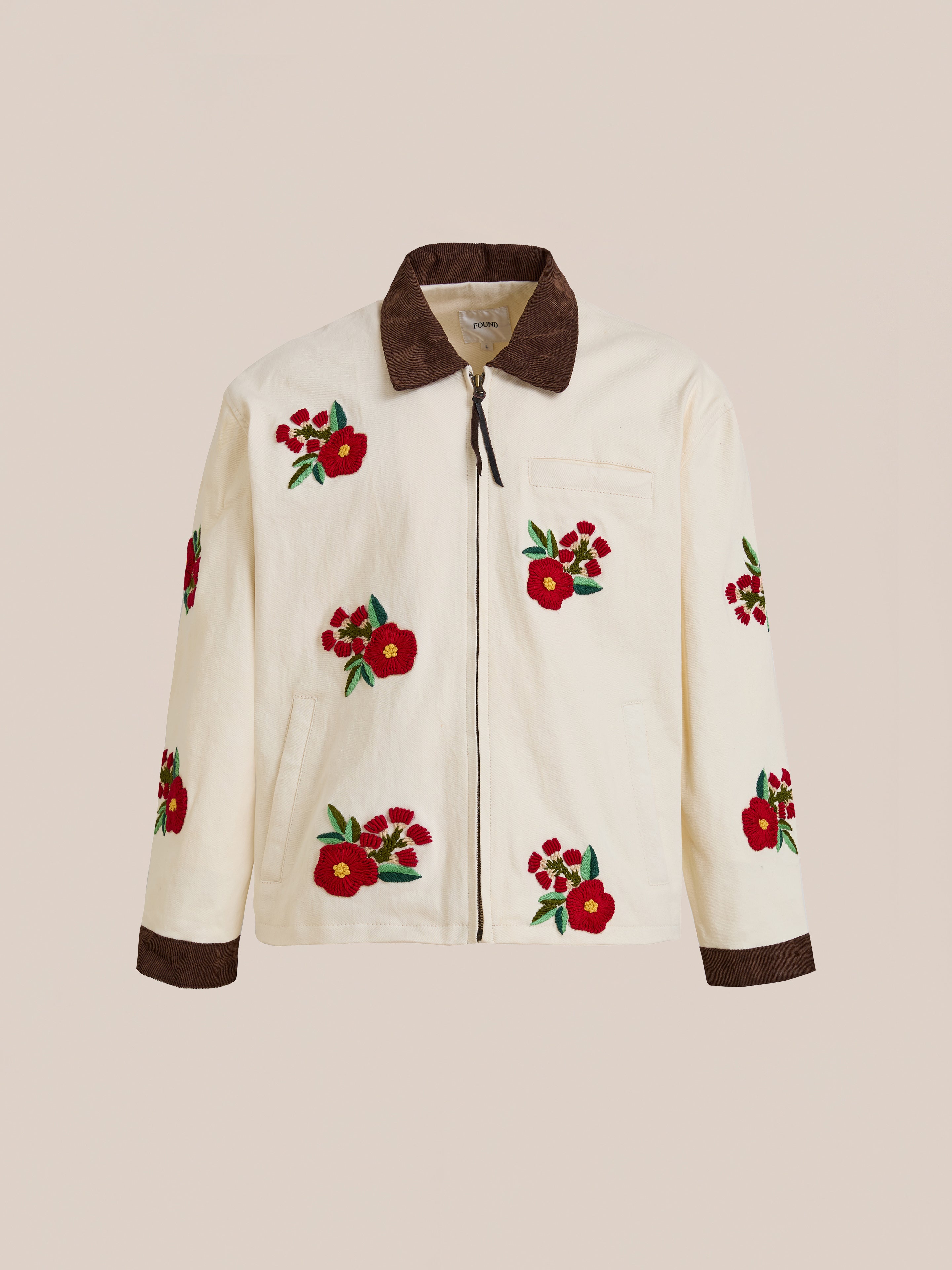 The Found Floral Hand Embroidered Work Jacket features cream fabric, brown collar and cuffs, and vintage South Asian-inspired floral embroidery on the front, sleeves, and back.