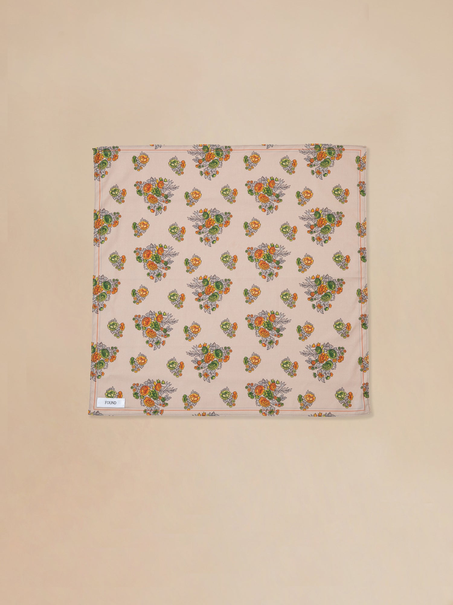 A Found floral print bandana with pink, orange, and green motifs inspired by nature.