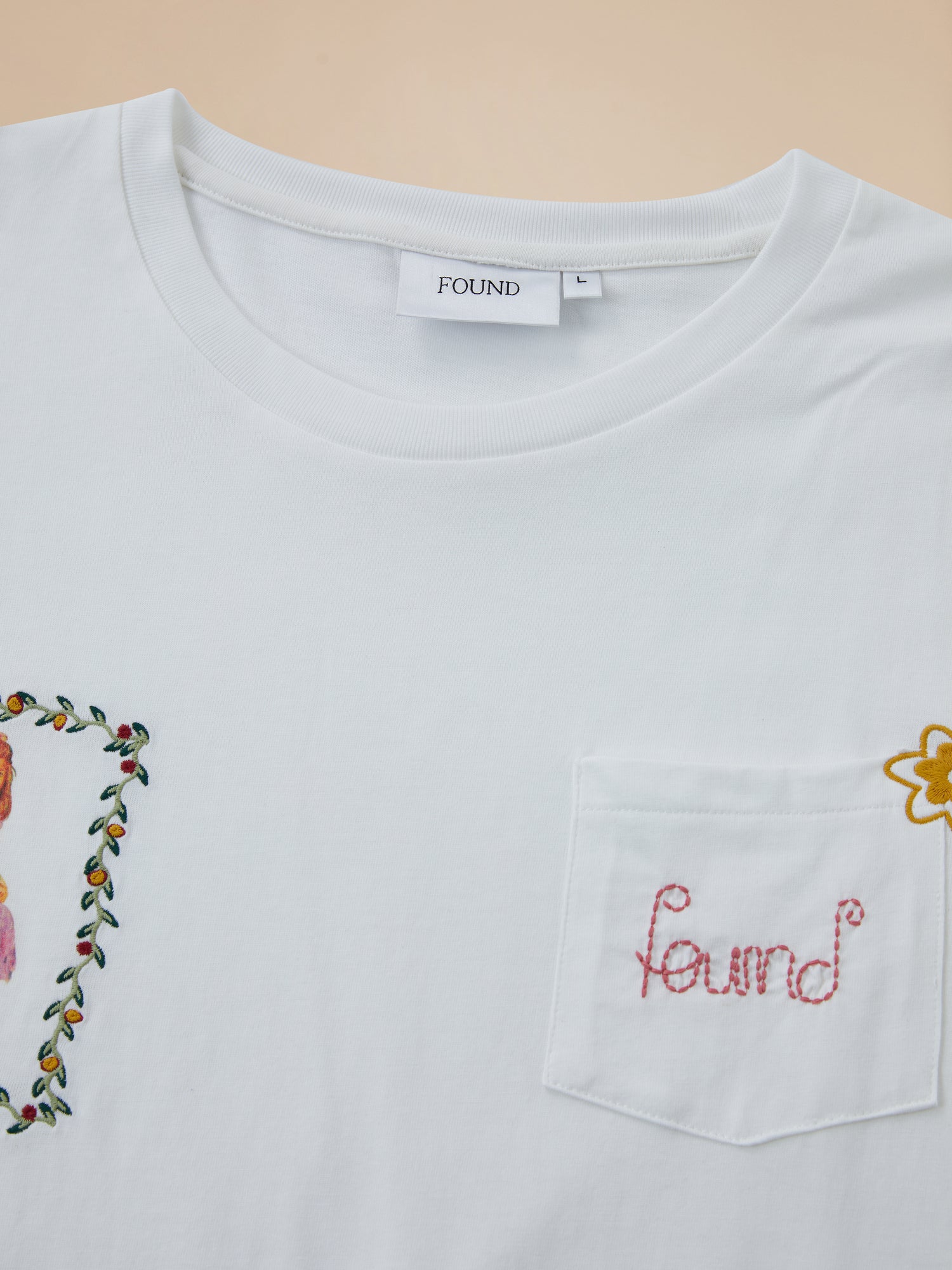 A white Flower Children Tee with a floral Phulkari style embroidered pocket from Found.