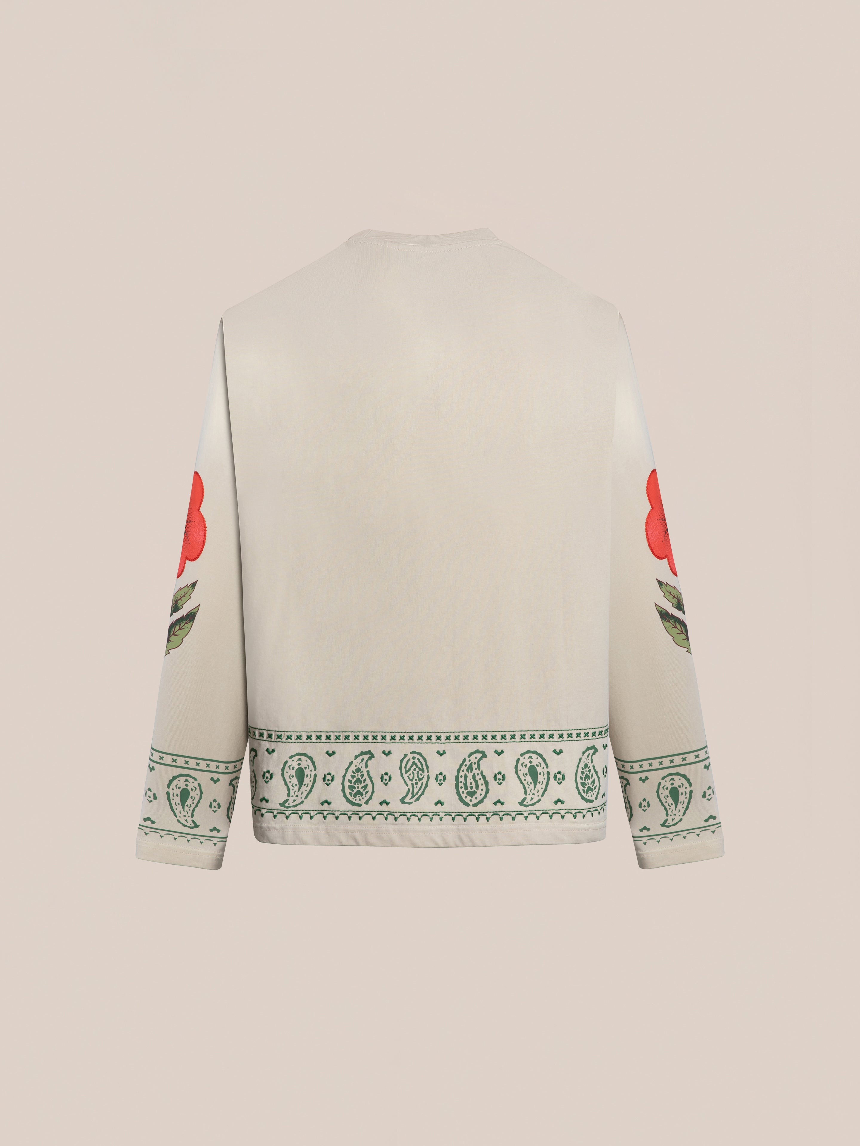 The FOUND Garden Bloom Embroidered LS Tee, shown from the back in a unisex relaxed fit, is cream-colored with green paisley near the hem and large red floral embroidery on the sleeves.