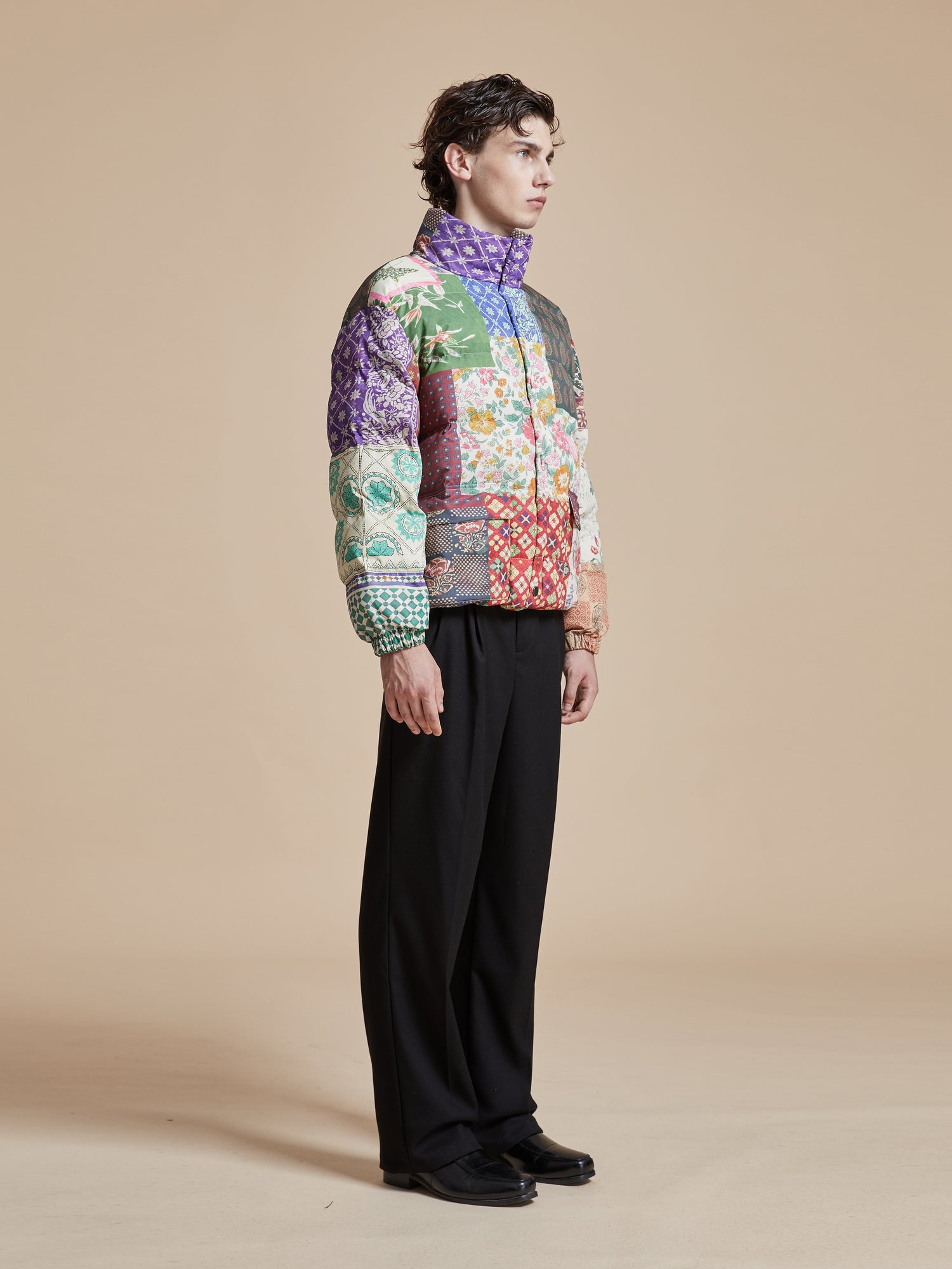 A man wearing a Found Gardenia Tapestry Puffer Jacket.