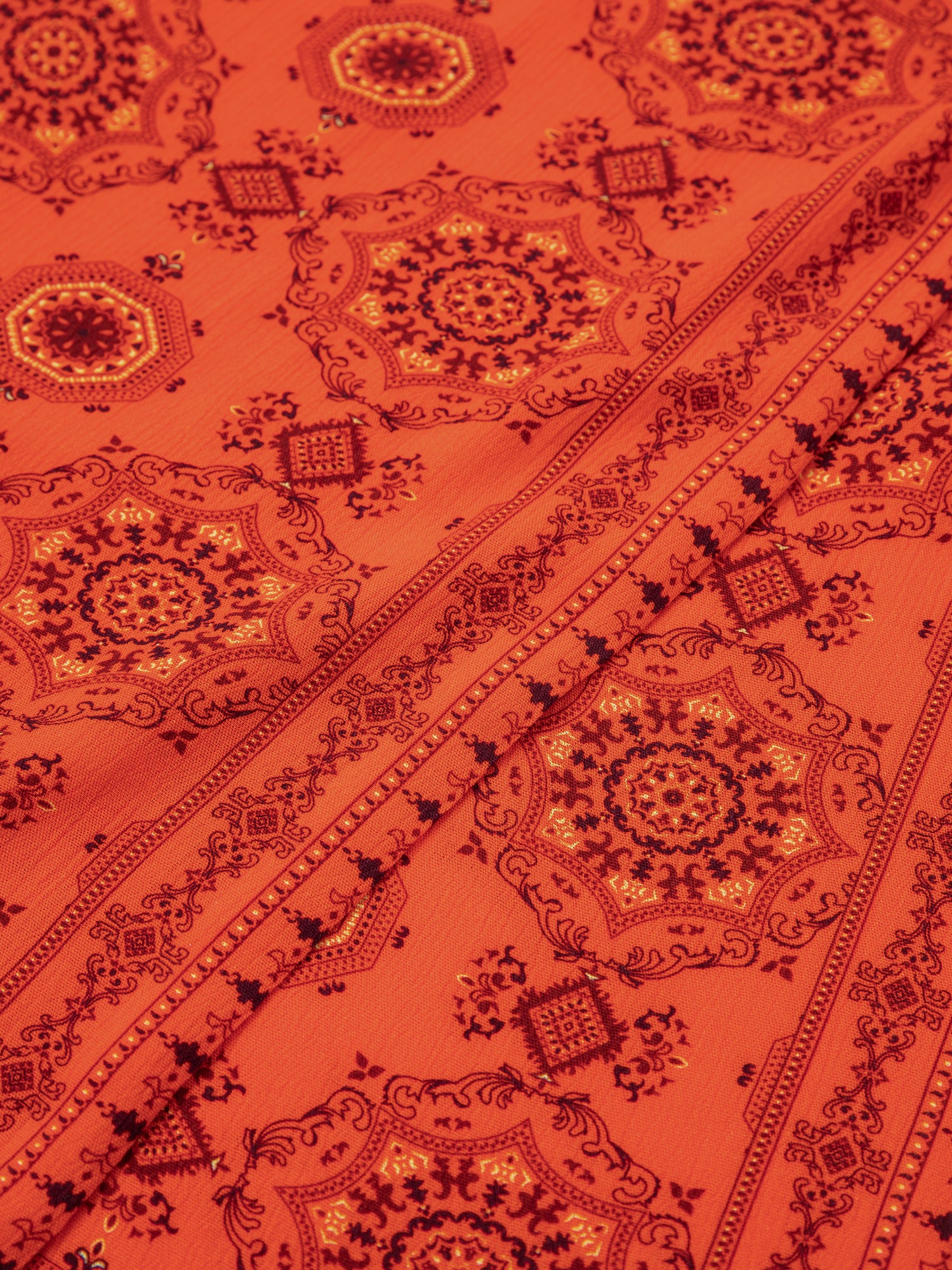 A close up of a Found Grenadine Scarf with Indo-Aryan prints.