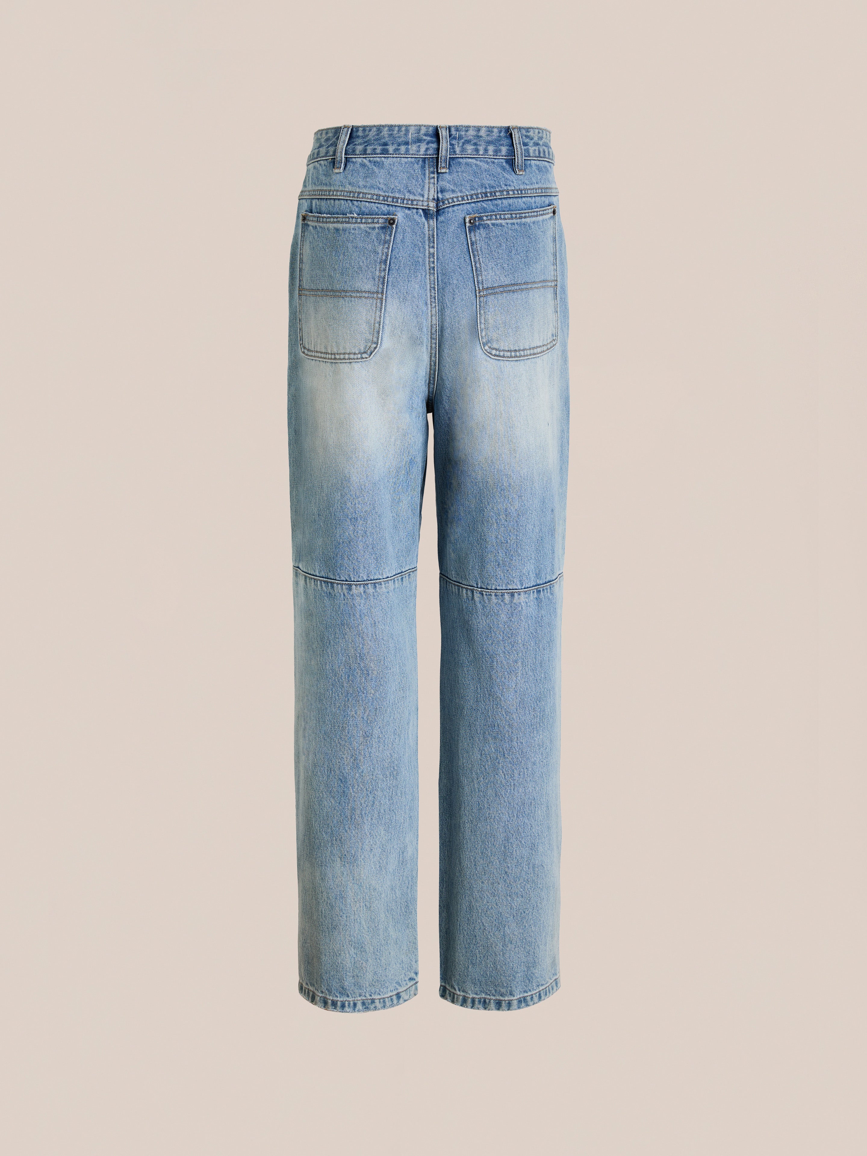 Back view of FOUND Hand Art Jeans: light wash, high-waisted straight-leg denim with bold print, two large back pockets, and visible seam detailing.