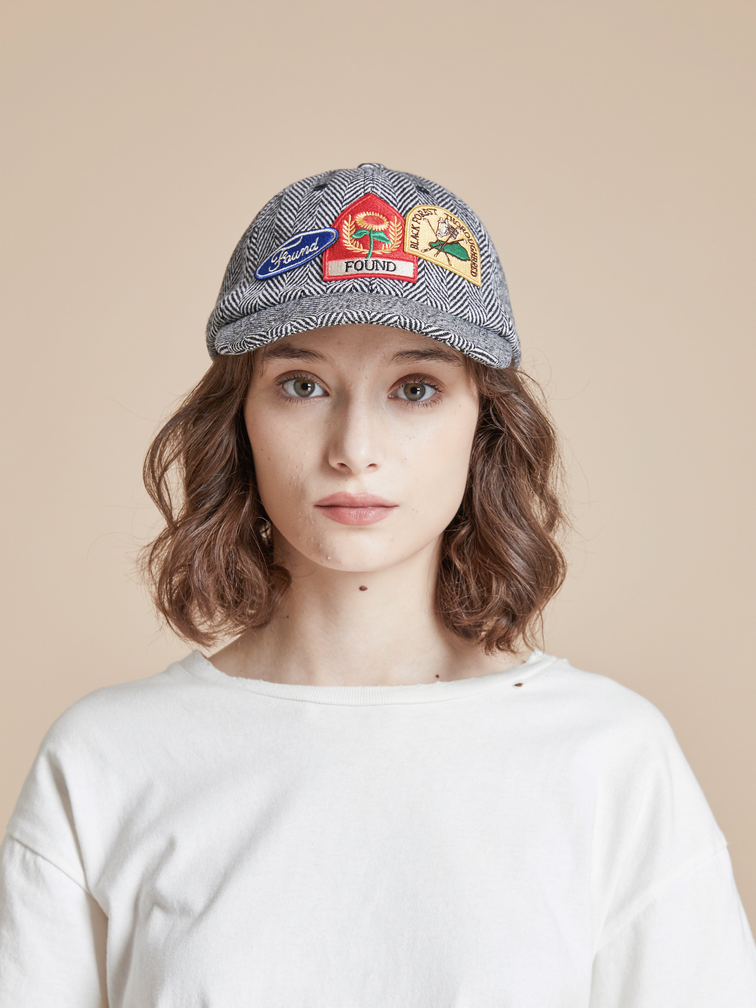 A woman wearing a Found Herringbone Tweed Patch Cap.