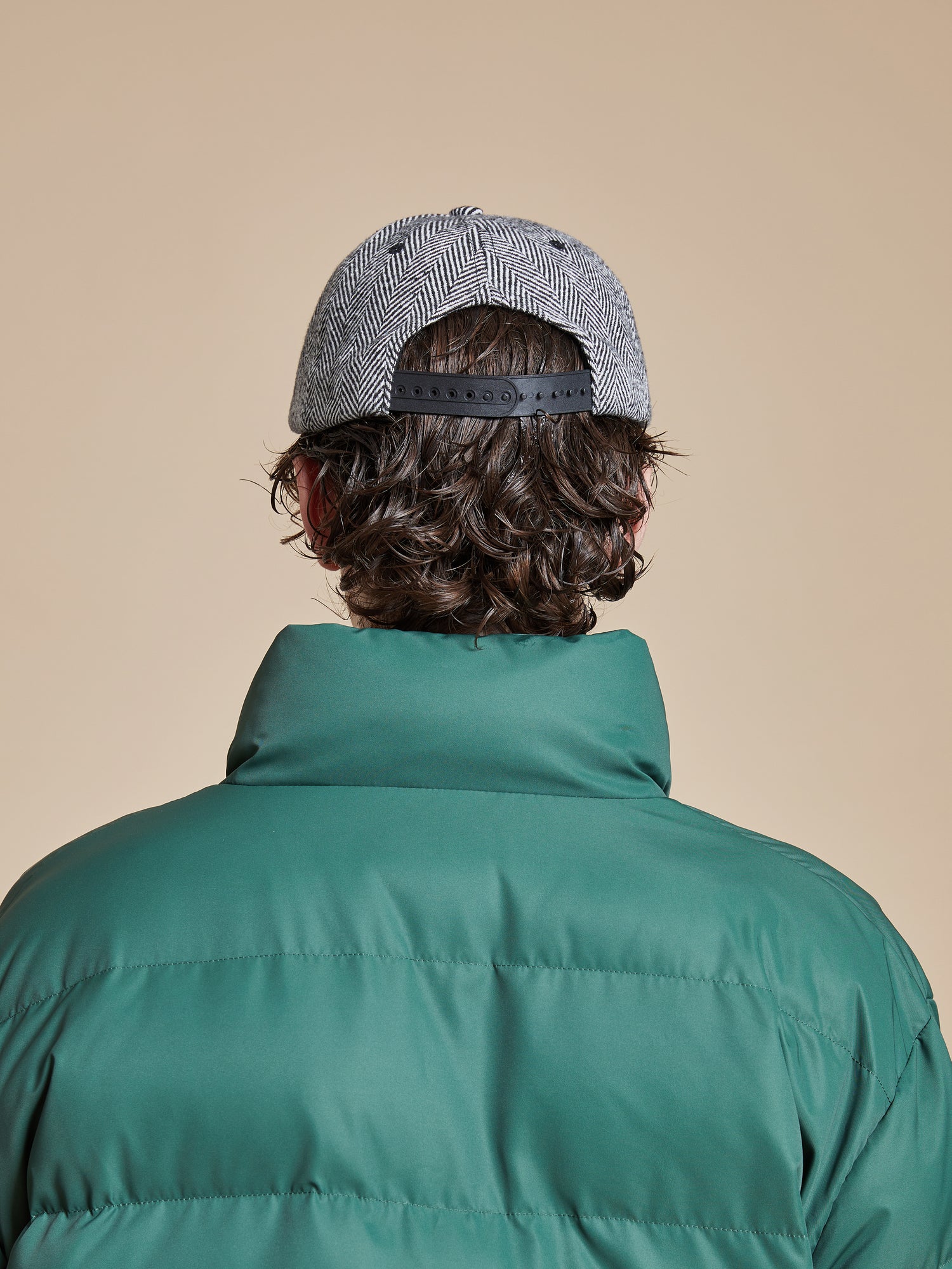 The back view of a man wearing a Found Herringbone Tweed Patch Cap.