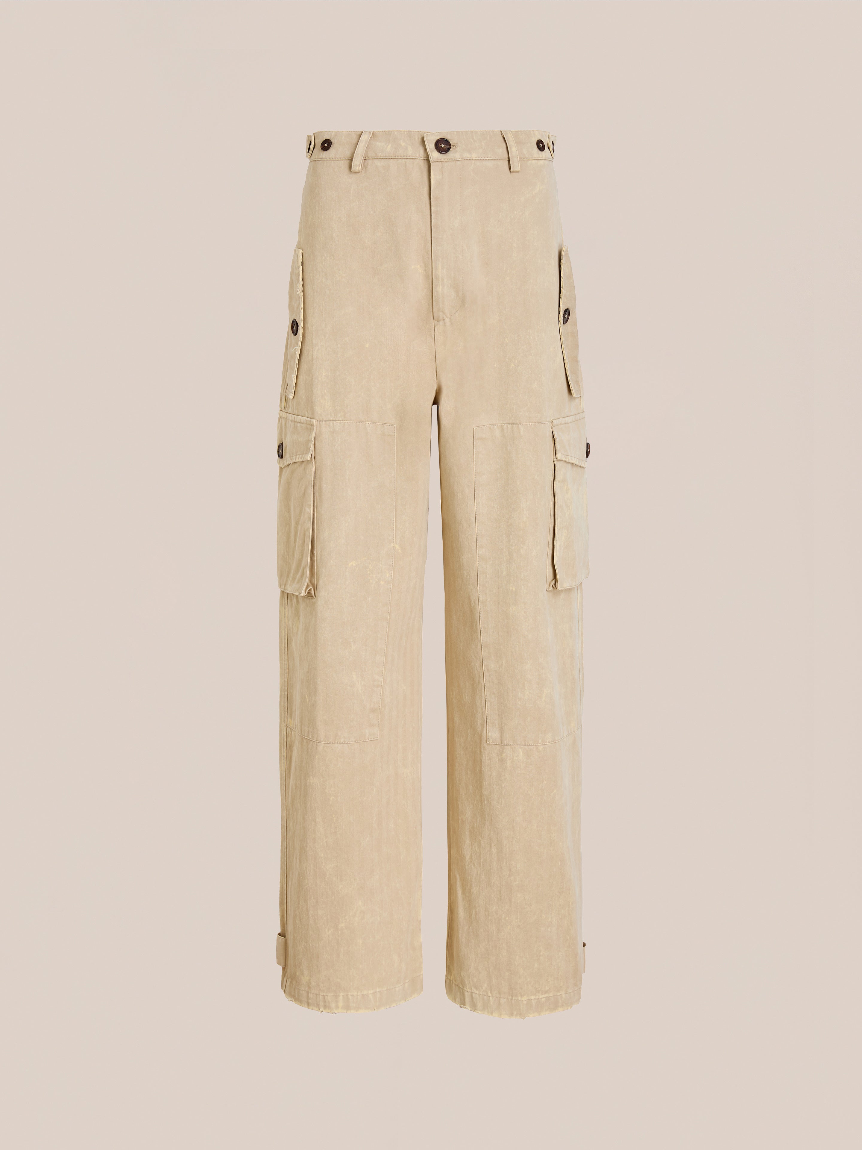 FOUND Utility Herringbone Paneled Pants in beige, featuring side buttoned flap pockets, wide legs, belt loops, and a unisex relaxed fit, shown against a plain light background.