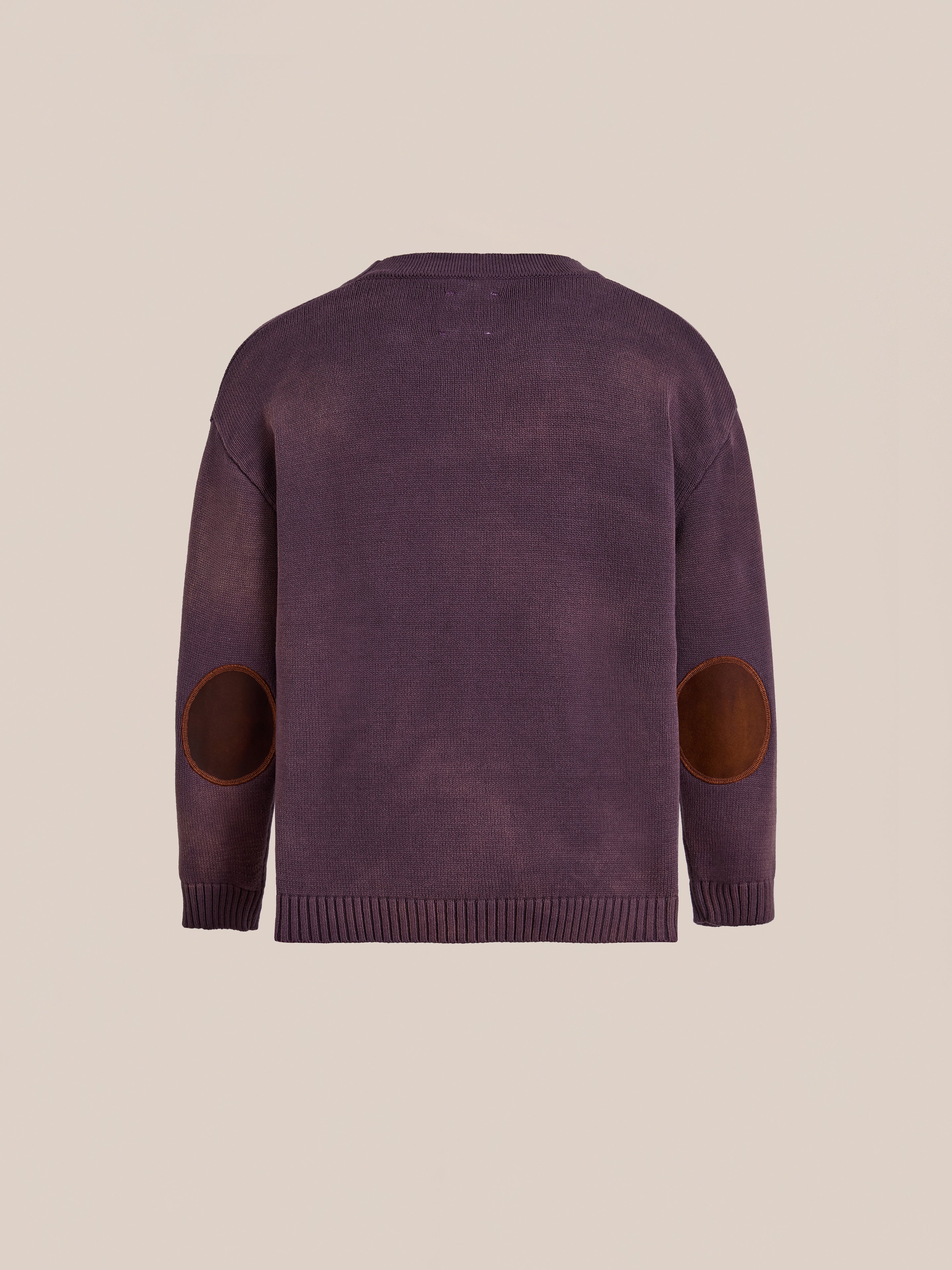 The Found Horse Jacquard Cardigan is a purple unisex long-sleeve sweater with brown elbow patches, displayed from the back on a plain beige background.