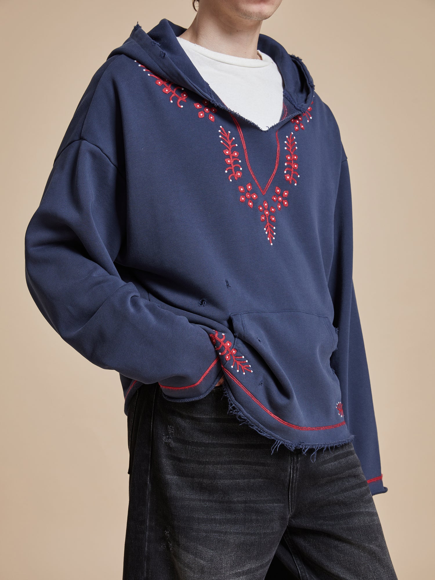 The model is wearing a Found Indus Embroidered Hoodie.