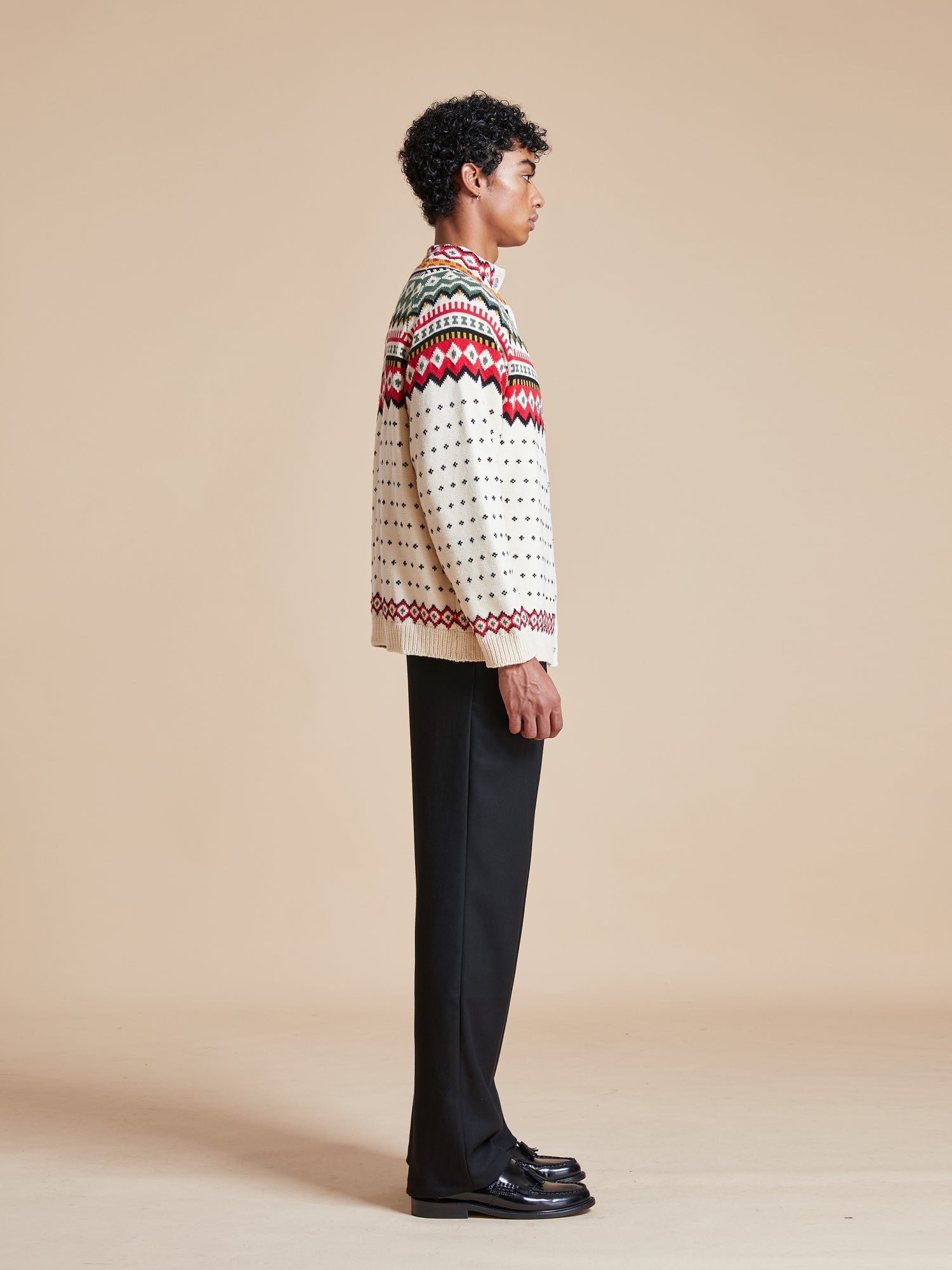 A man wearing a Harwan Isles sweater from the Found brand.