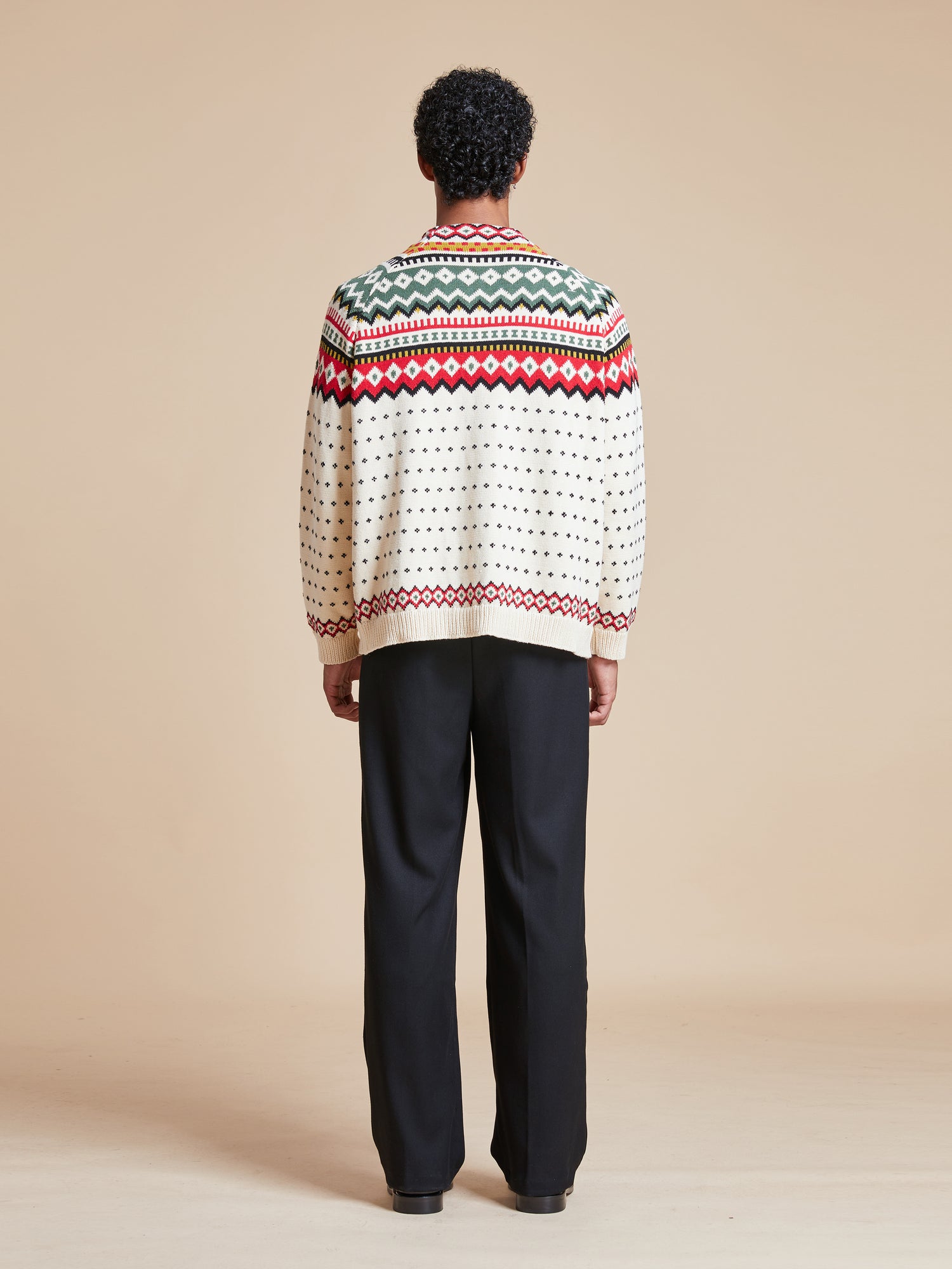 A man wearing a Found Harwan Isles sweater.