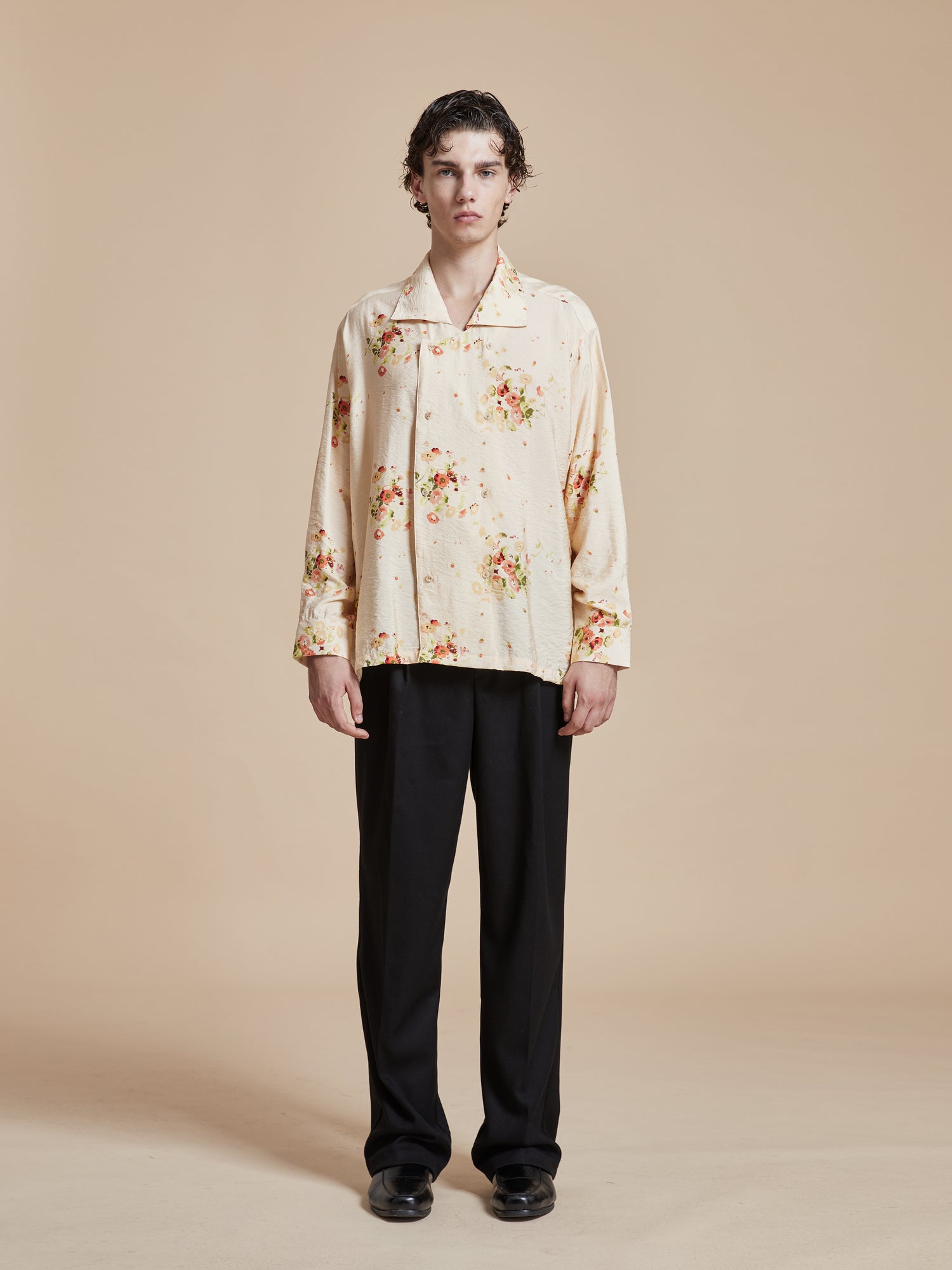 A man wearing a Found Kanhati Garden Long Sleeve Camp Shirt with Phulkari motifs.