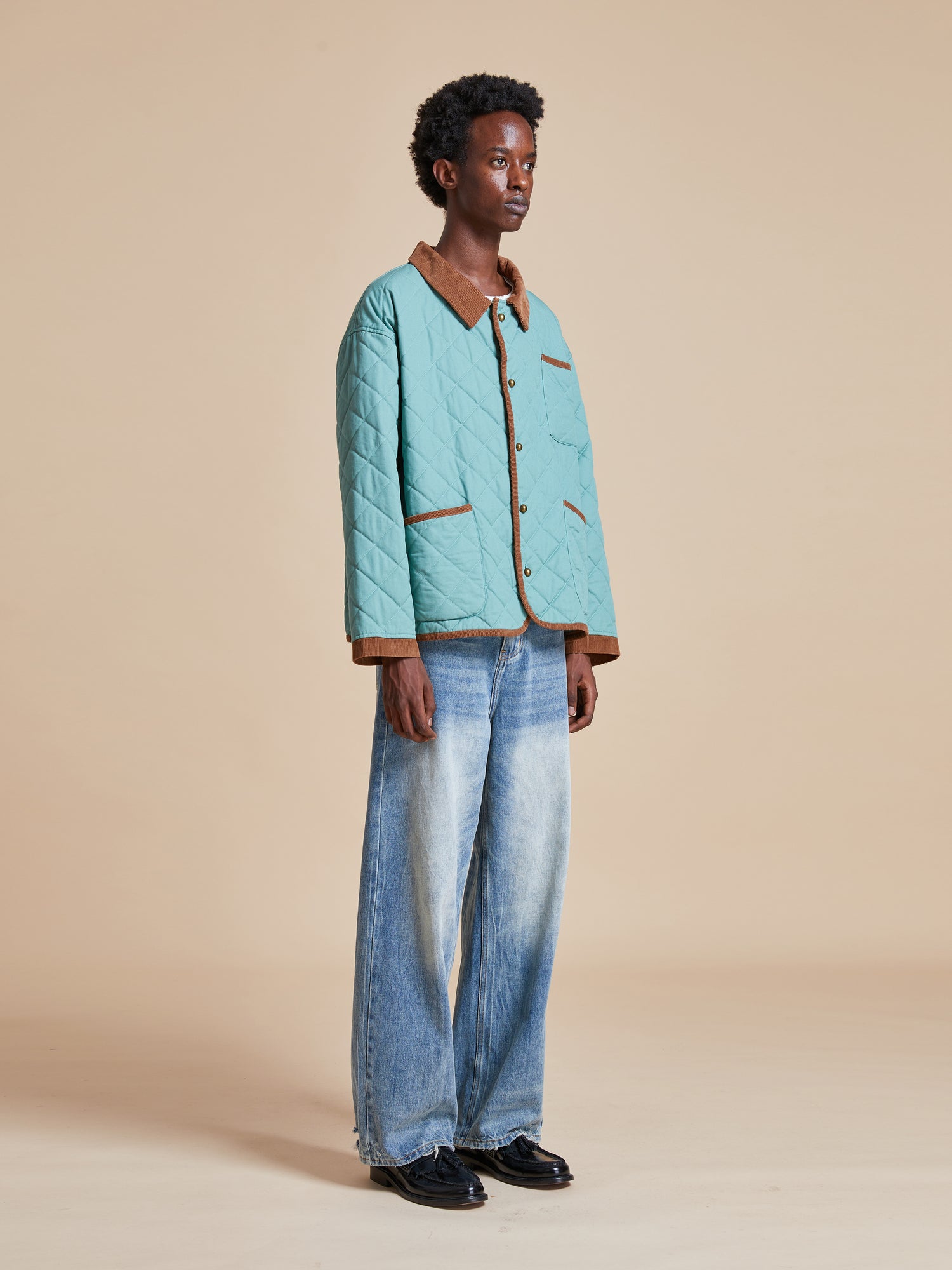 A woman wearing a Kashmir Meadow Quilt Jacket by Found and jeans.