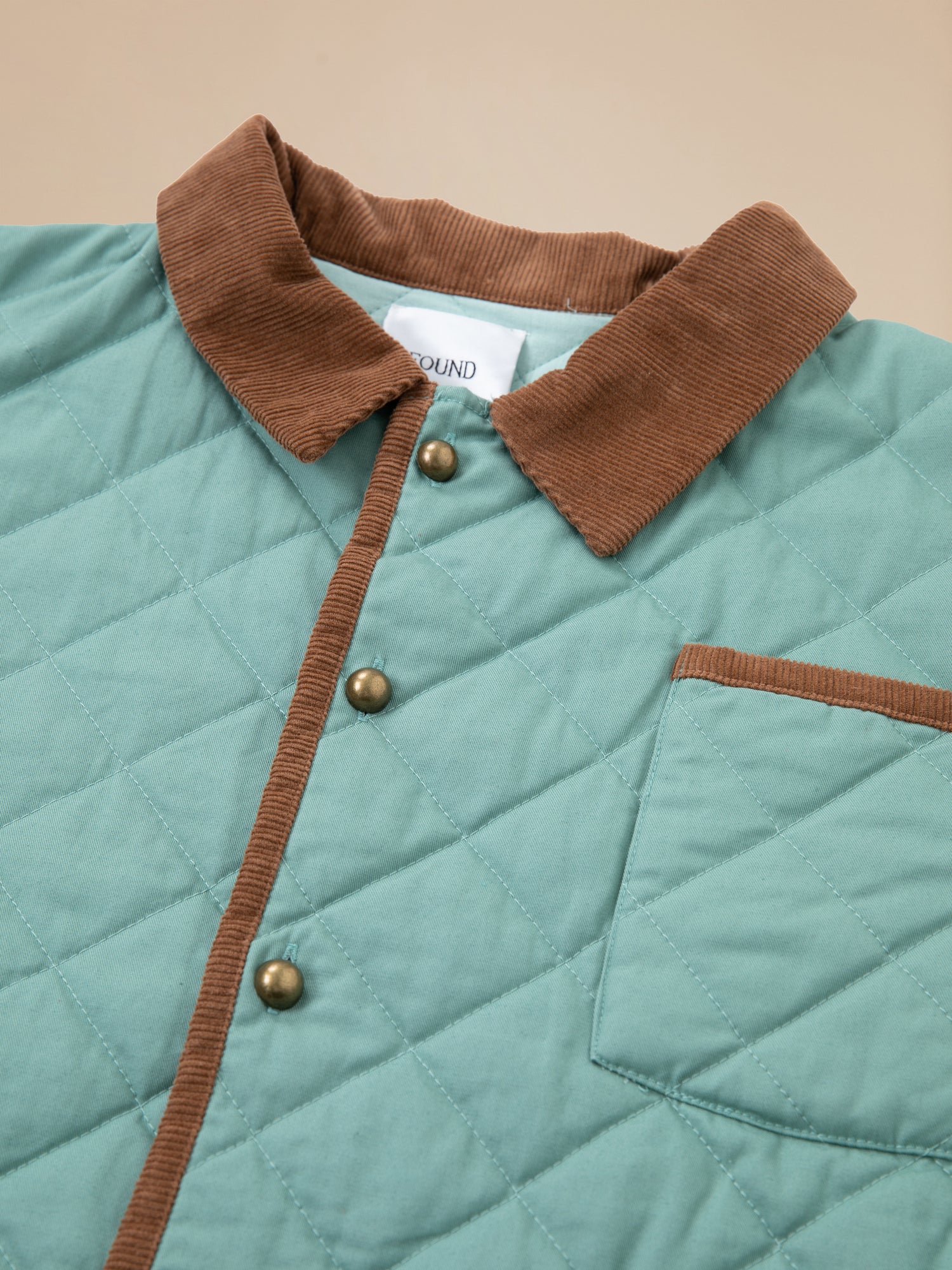 A Kashmir Meadow Quilt Jacket by Found with brown buttons.