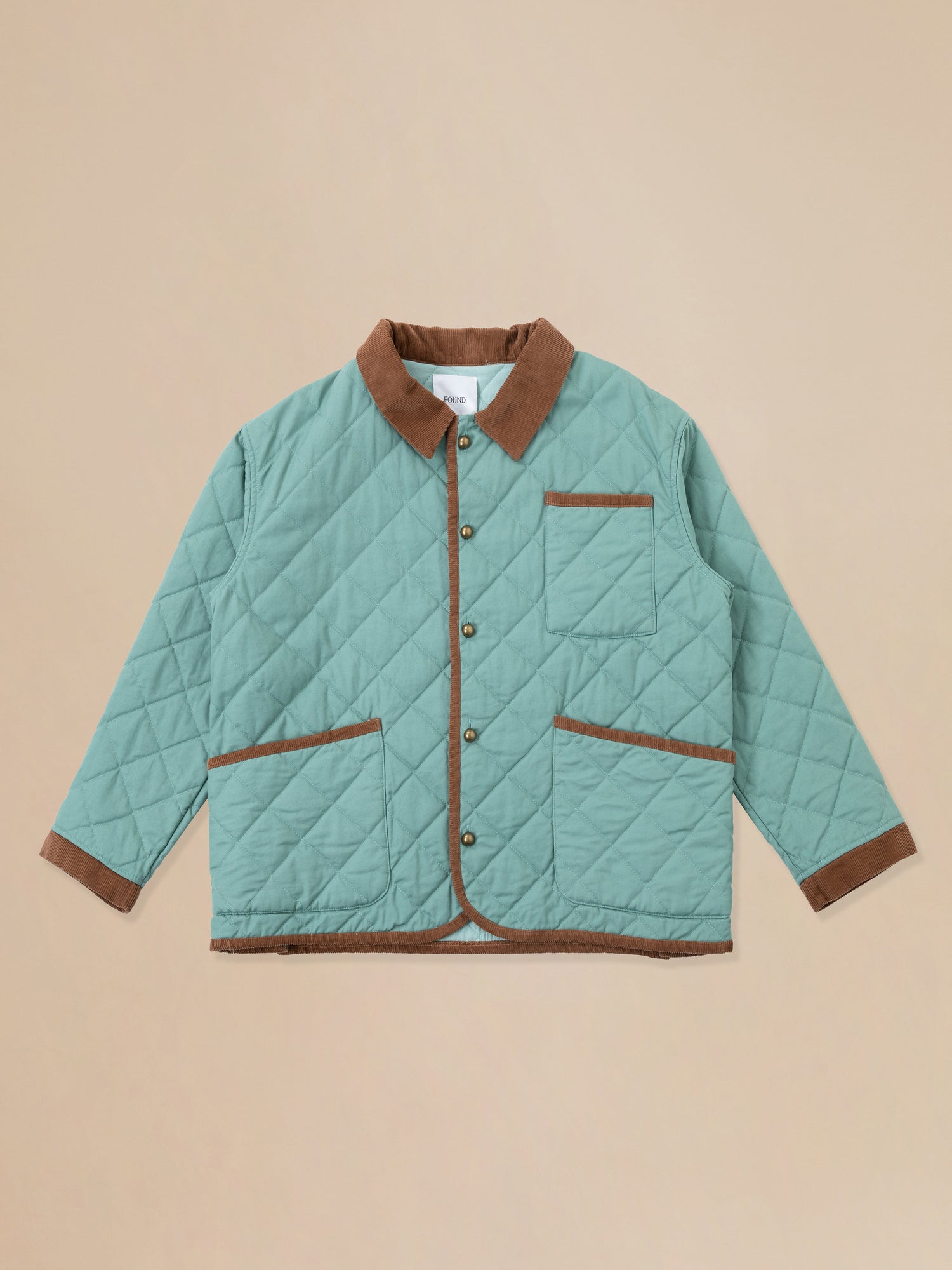 A Found Kashmir Meadow Quilt Jacket on a beige background.