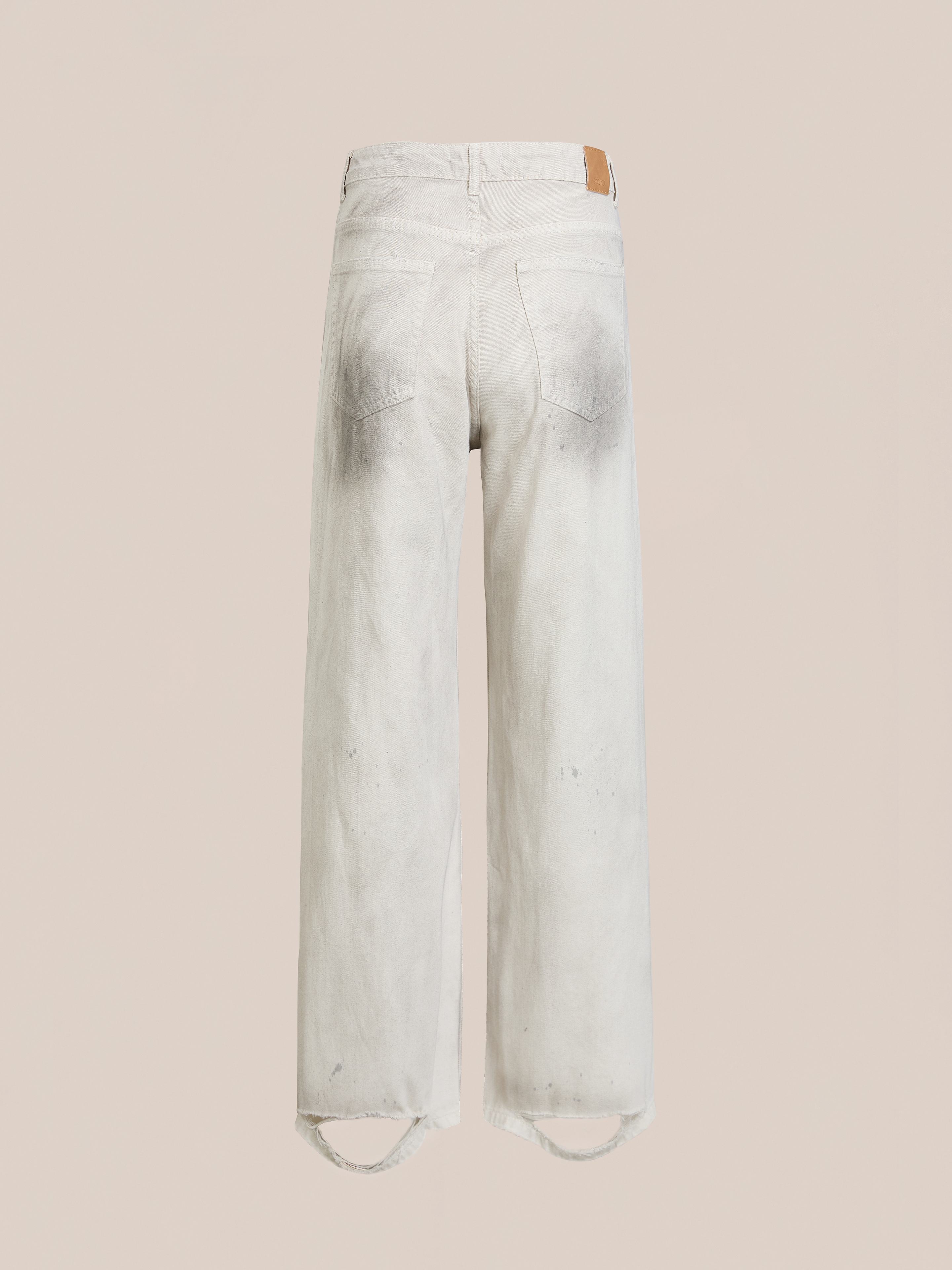 FOUND Lacy Baggy Jeans: Relaxed fit, wide-leg jeans in a light distressed concrete wash, seen from the back with two rear pockets and subtle faded details at seams and hem.