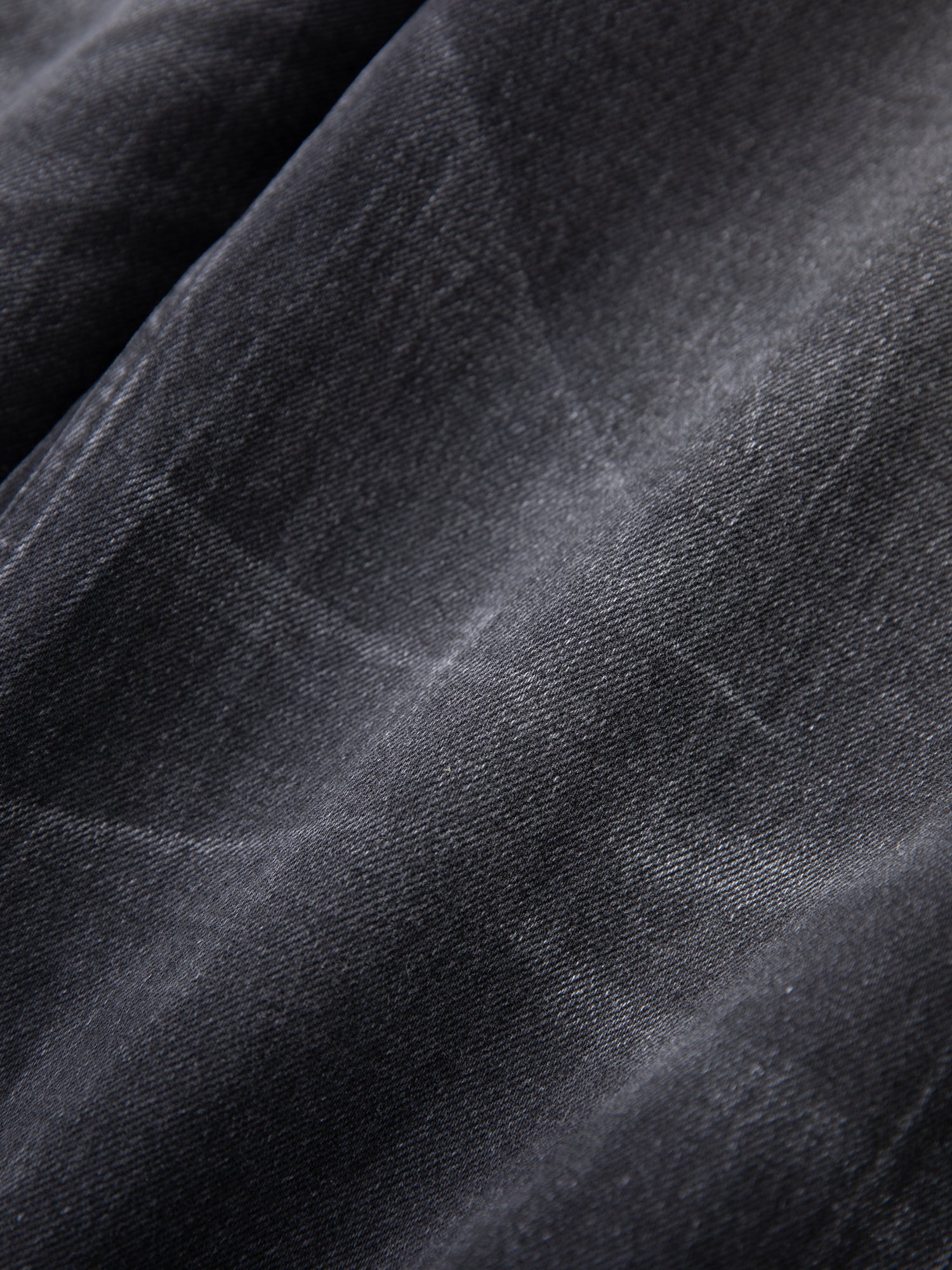 A close-up image of Found's Lacy Baggy Jeans in black wash fabric.